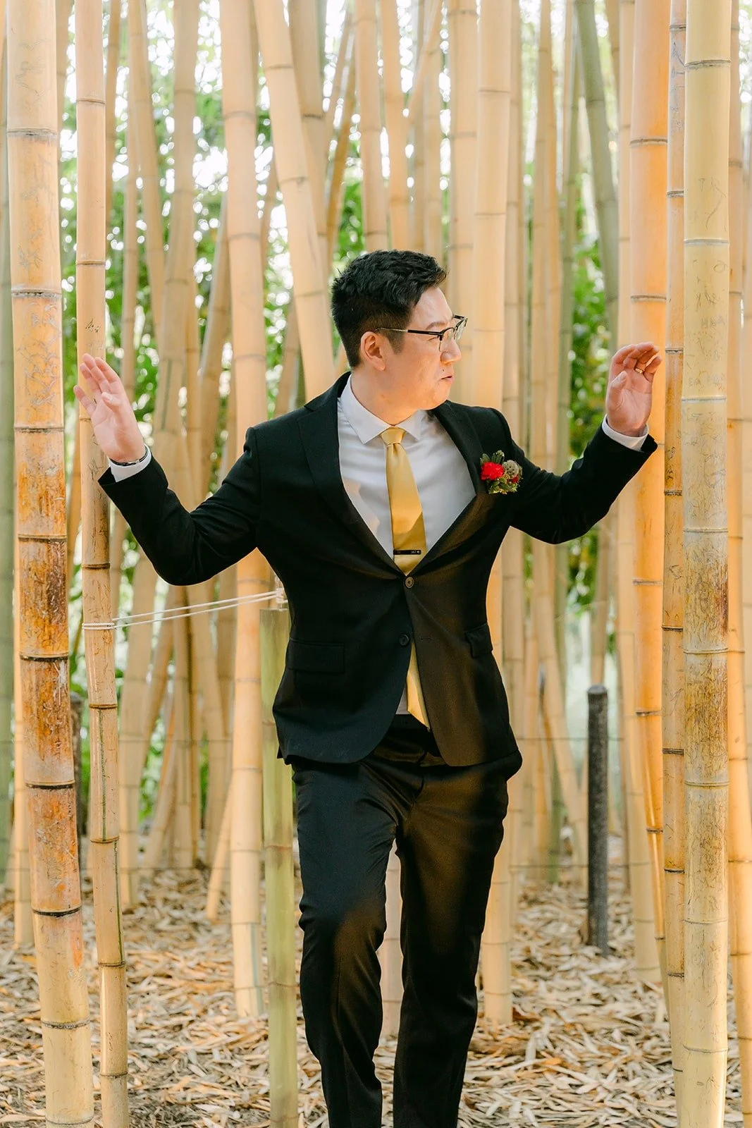 Zach striking a playful pose between the bamboo stalks