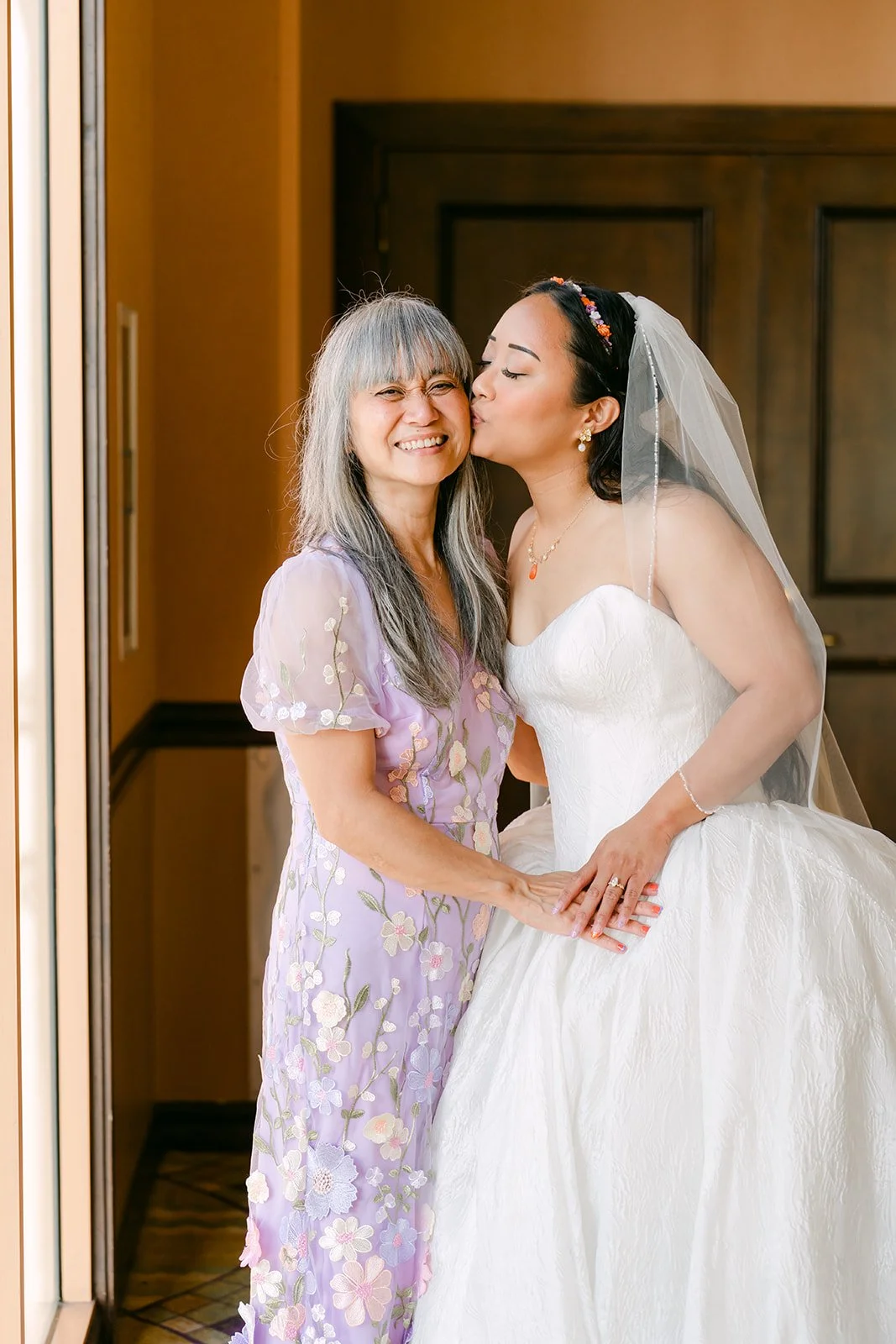 Angela's mom kissing her cheek