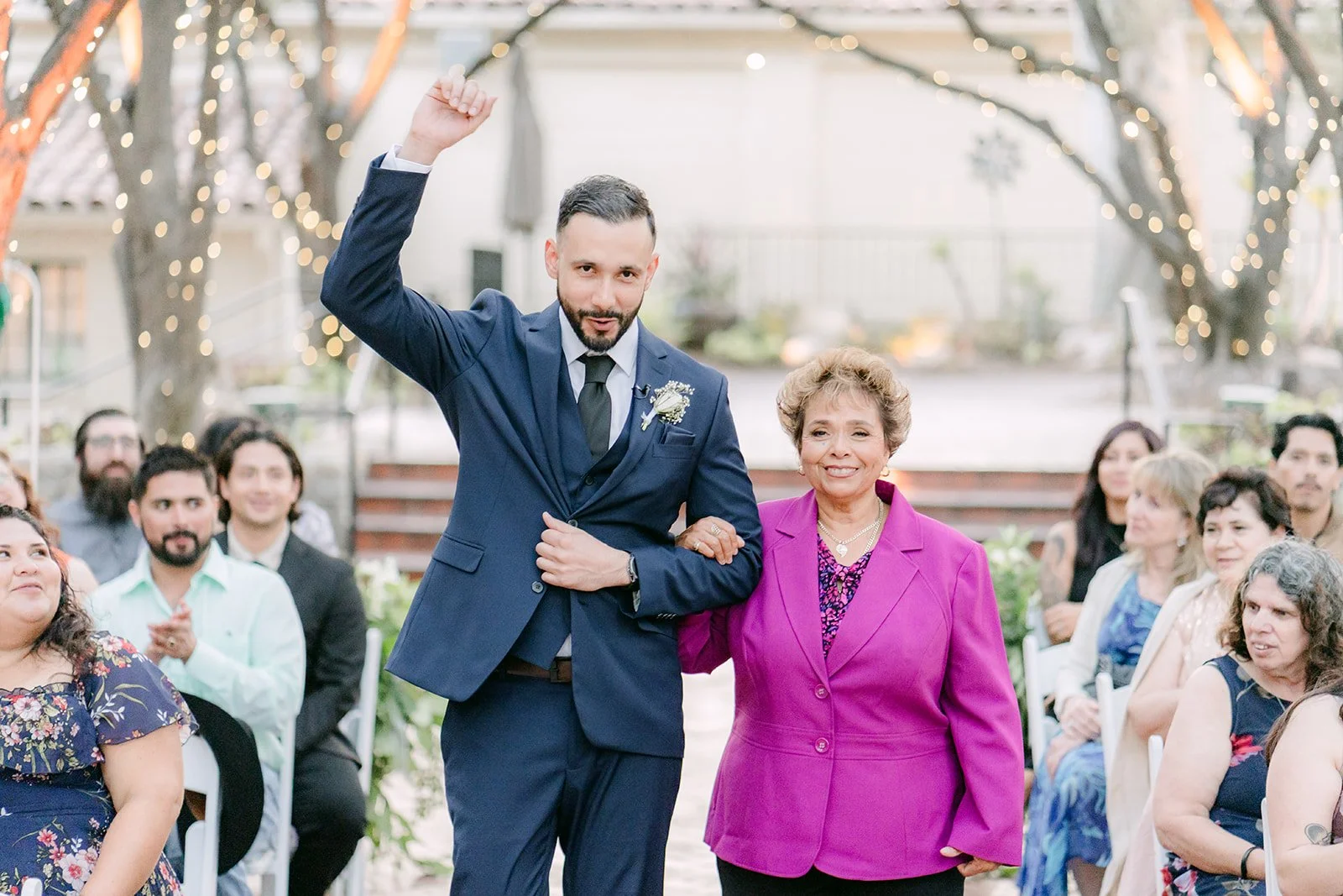 Danny raising his fist as he walks down the aisle with his mom