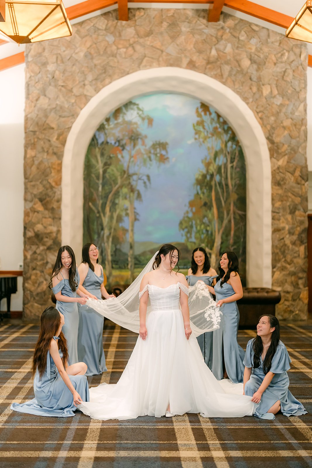 Bridesmaids fluffing Jessica's train