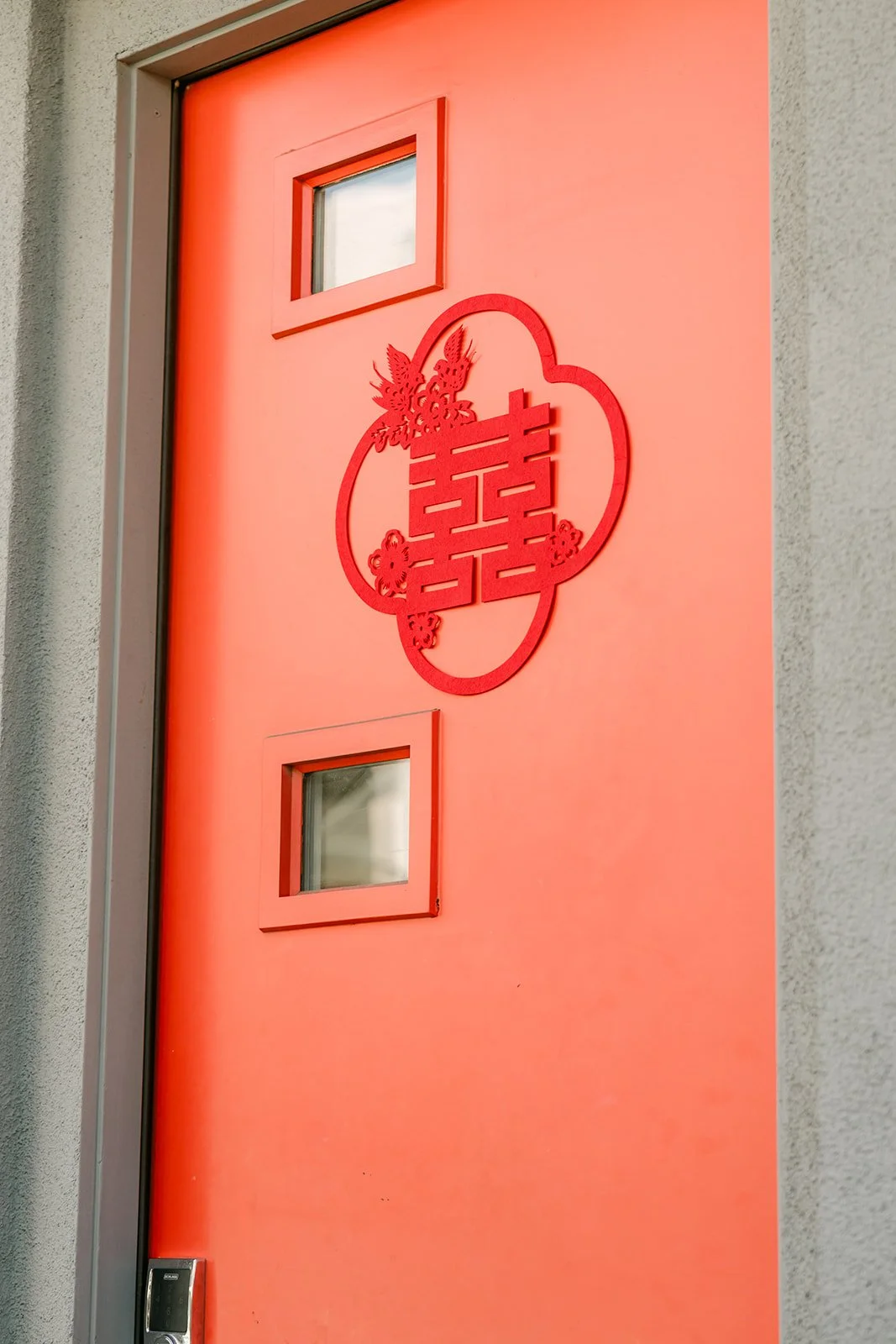 A red double happiness sign on the front door of Christian's family home.