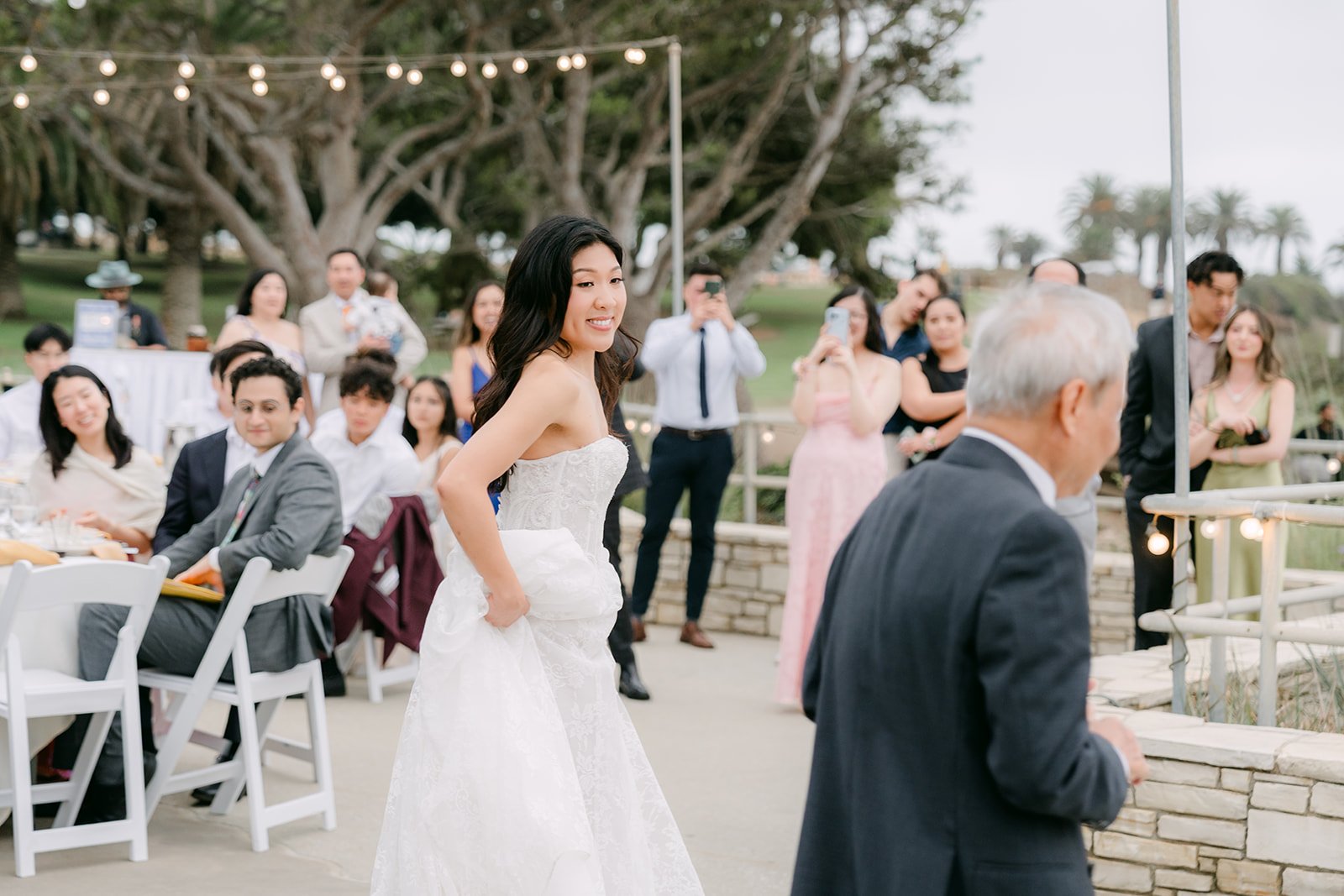 Kim dancing with her dad on the patio