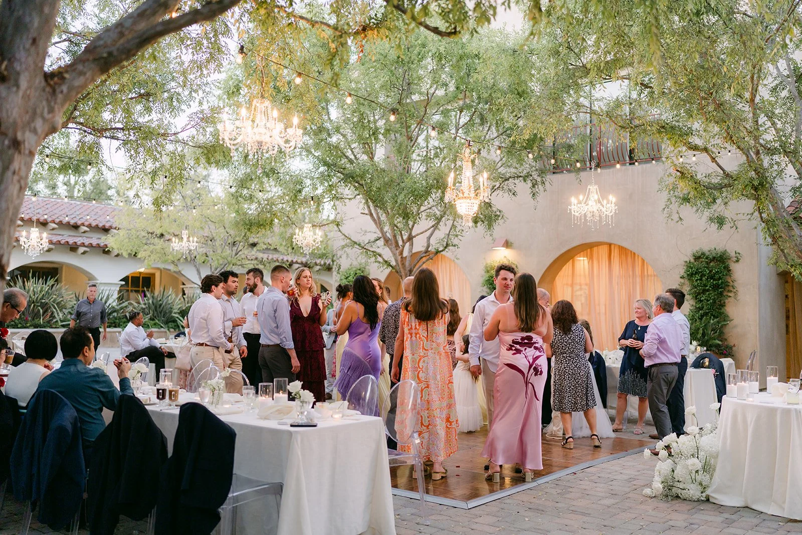 Guests mingling in the courtyard reception at Serra Plaza