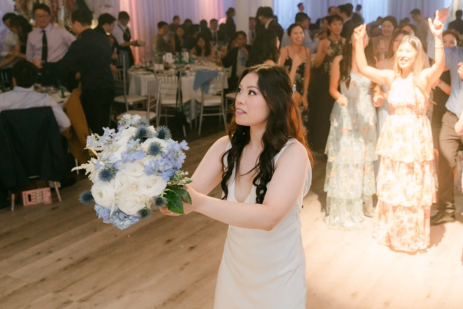 Emily getting ready to toss a Labubu instead of a bouquet