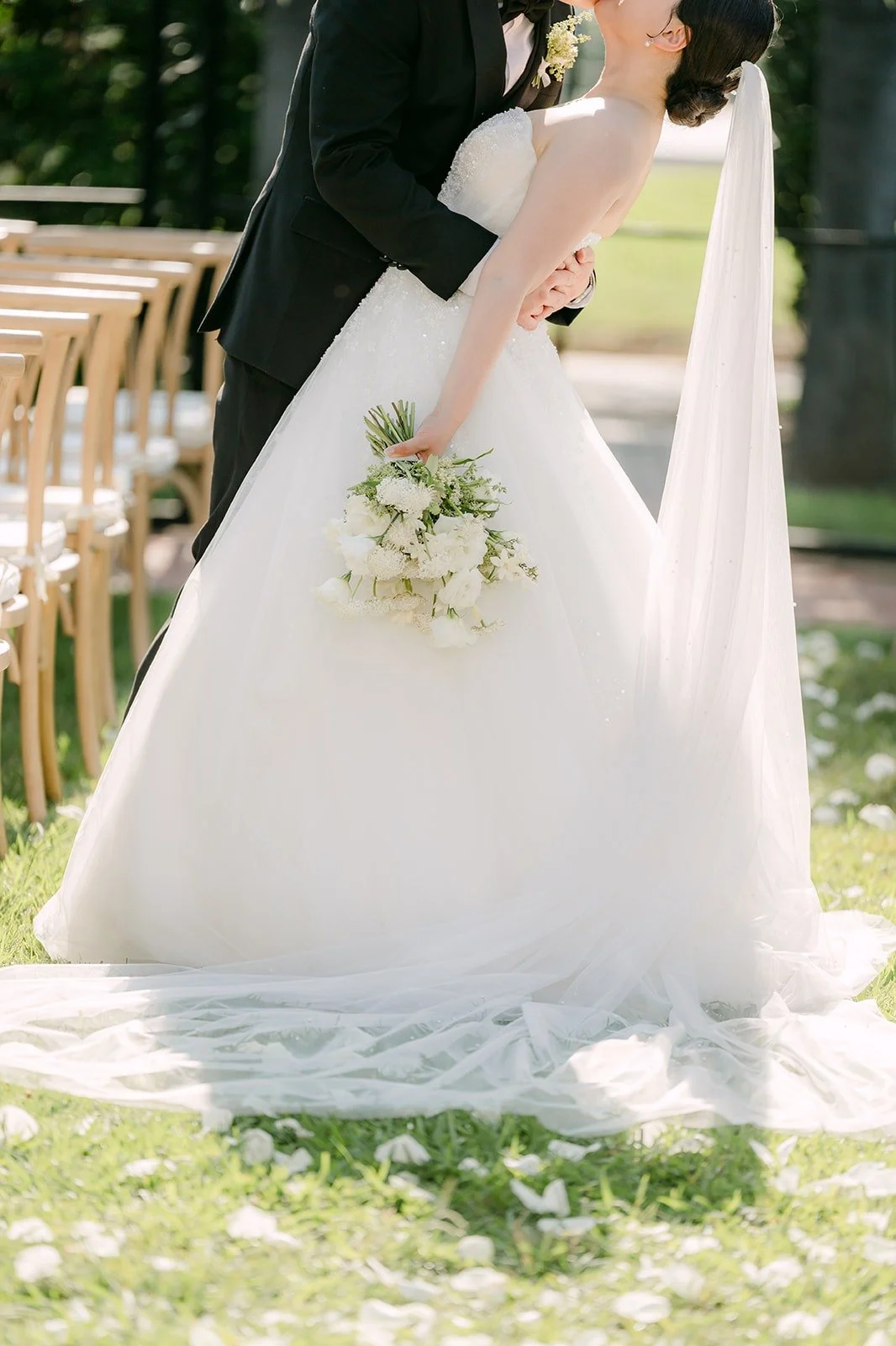 Amy's gown and bouquet on the ceremony aisle