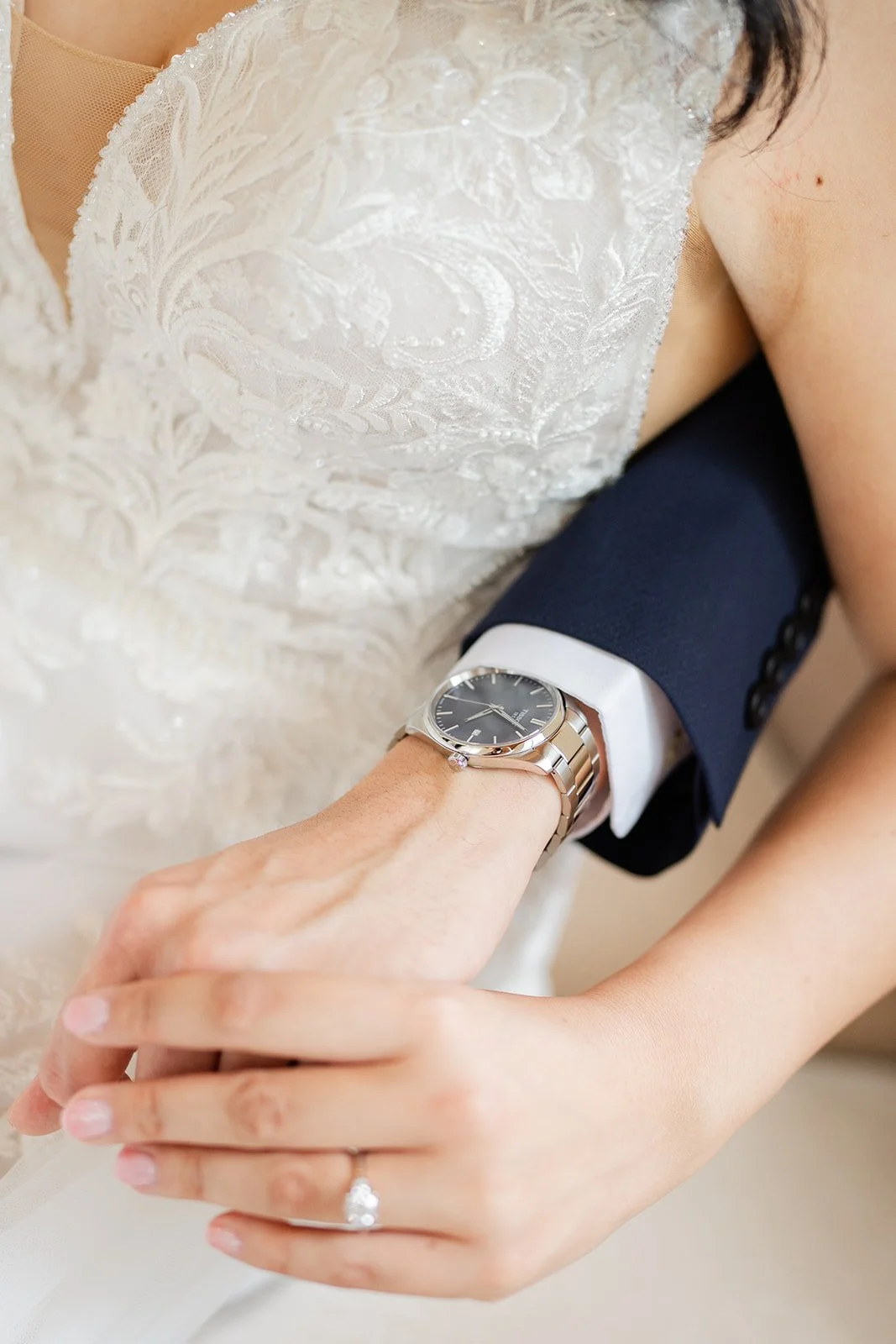 Close up of the couple's hands and wedding rings