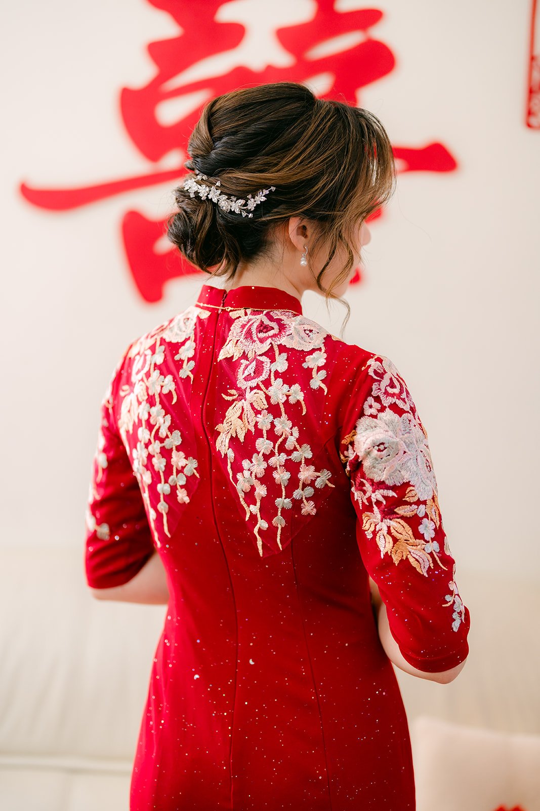 Pauline's hair and qipao from behind.