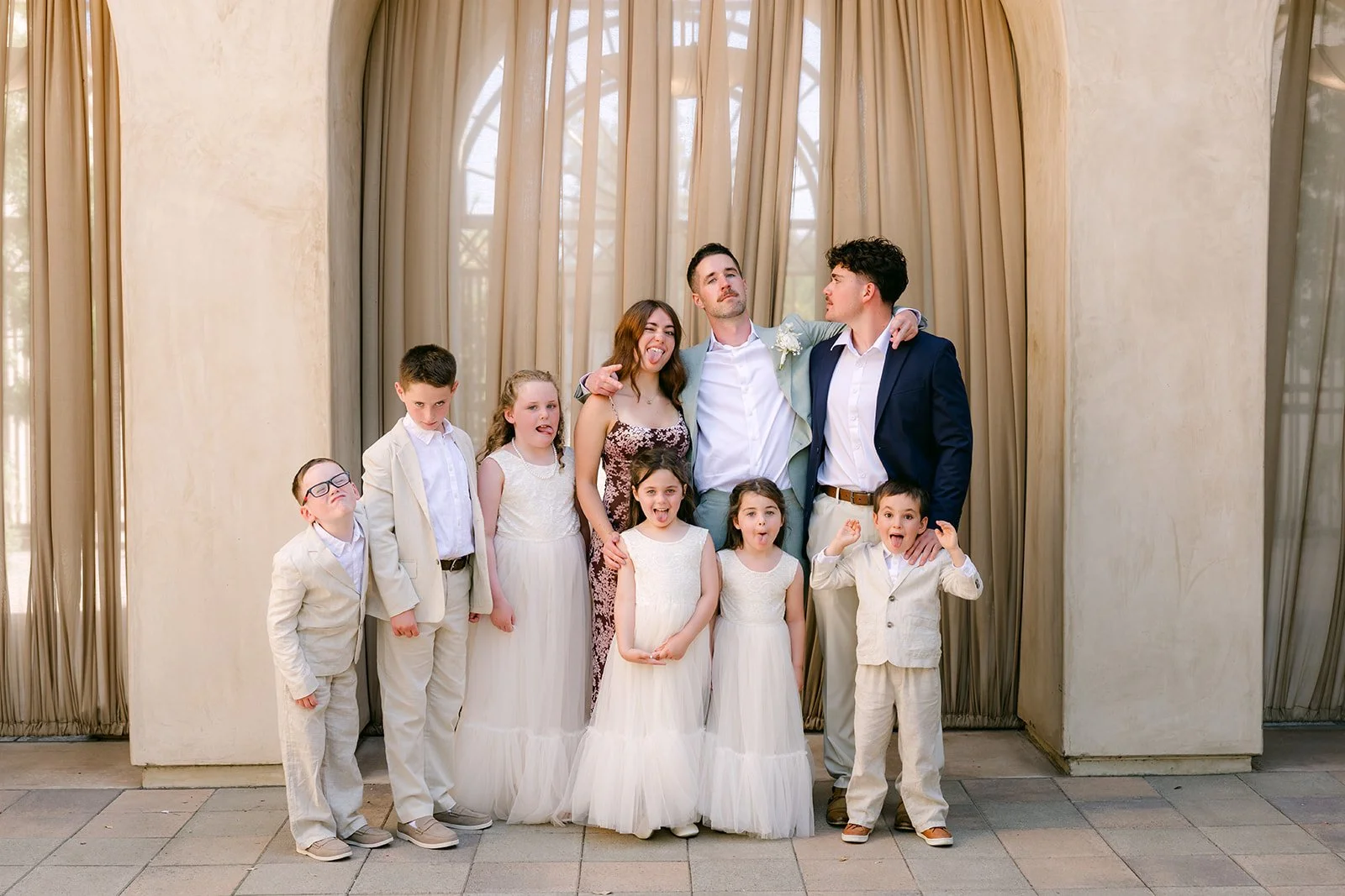 Groom posing with the ring bearers and flower girls