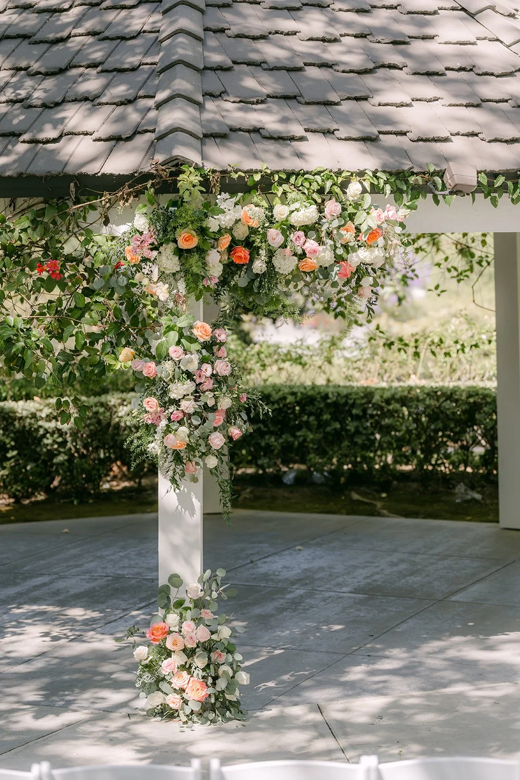 The gazebo framed with pink and white florals