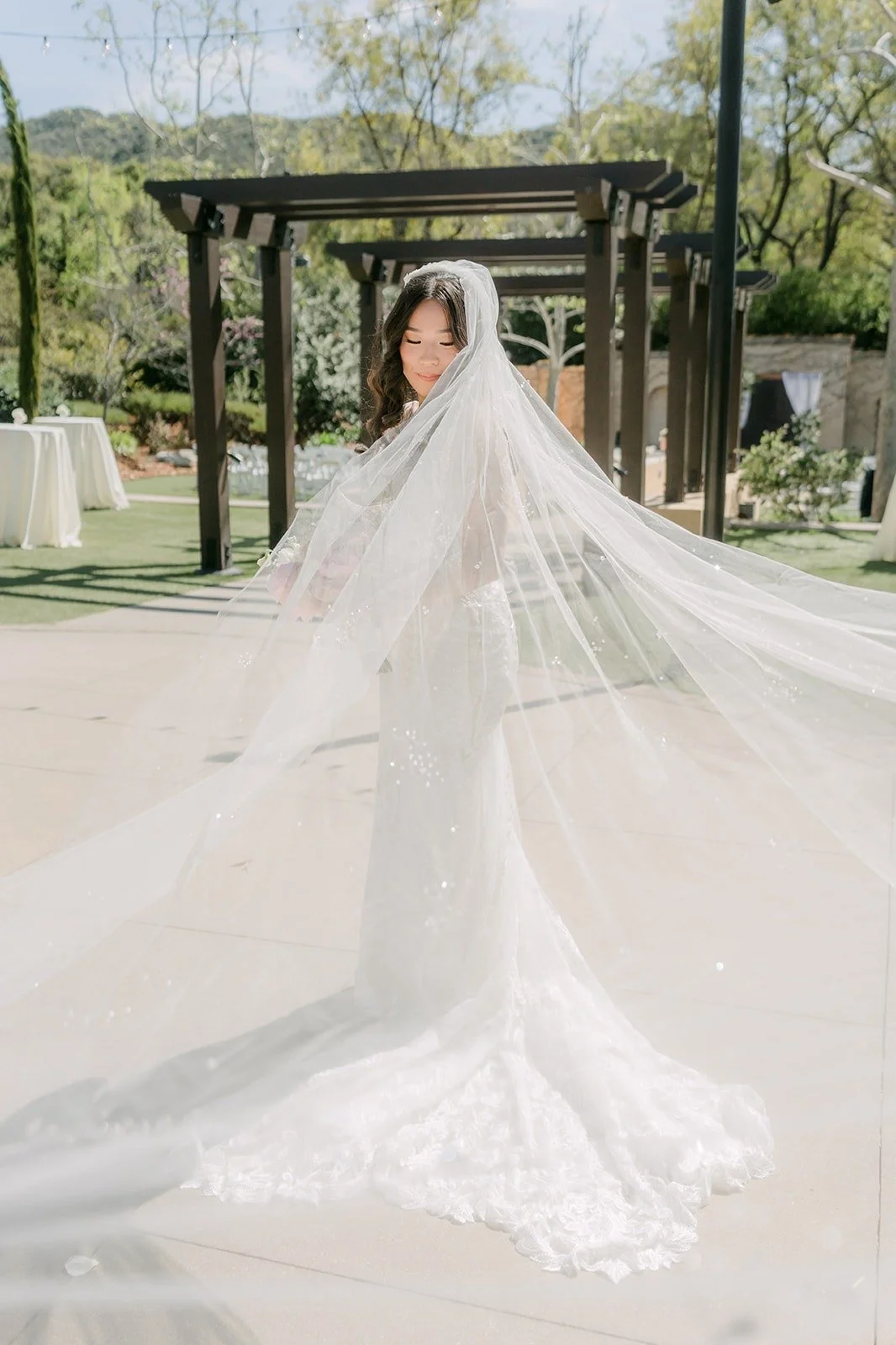 Kelli's long veil spread out on the patio under the pergola at Los Robles Greens