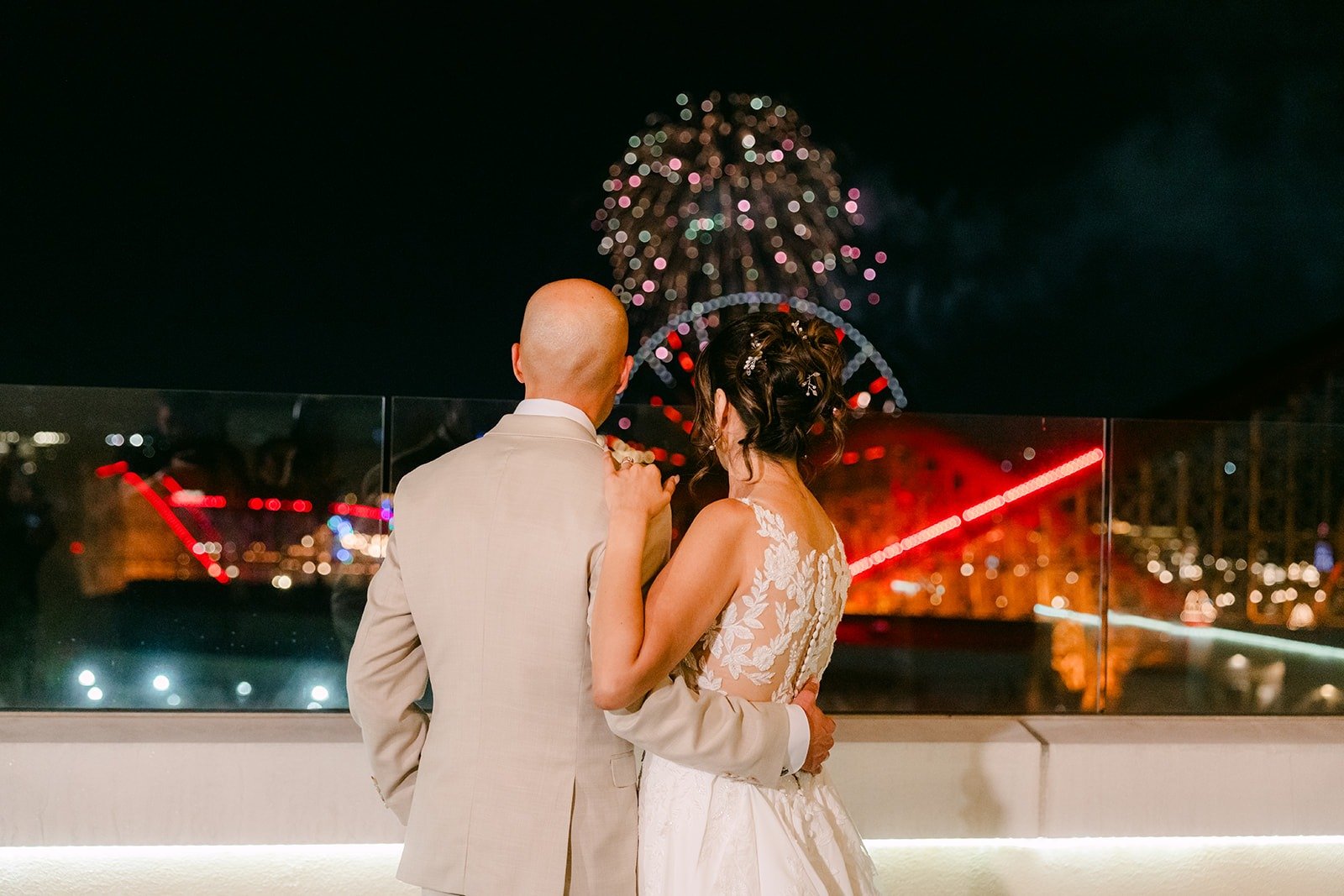 Francesca and Daniel kiss as fireworks fill the night sky