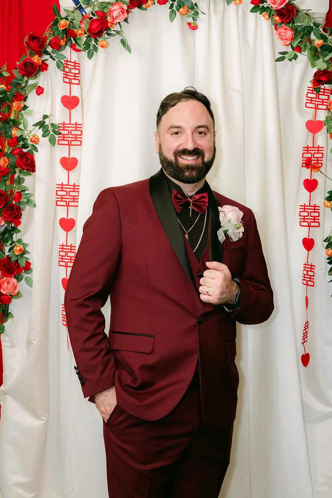 Ryan smiling with his hand in his pocket under the arch.