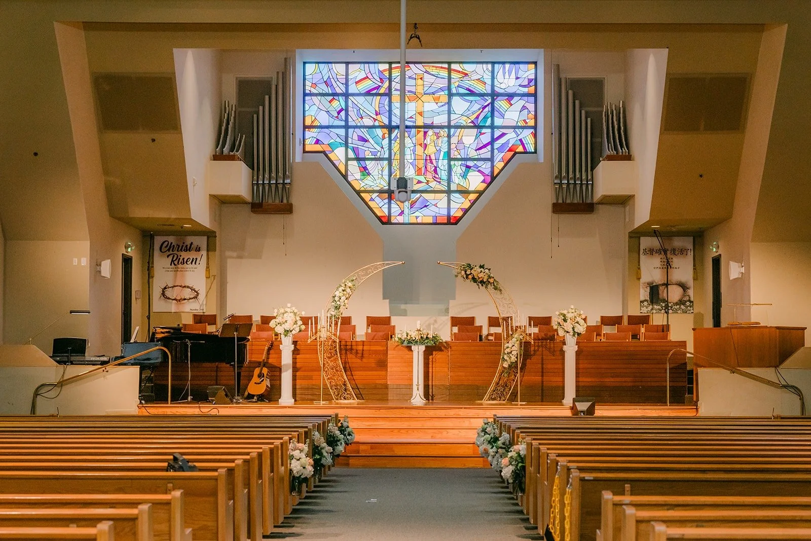 The sanctuary at Mandarin Baptist Church of Los Angeles with its stained glass window above the altar