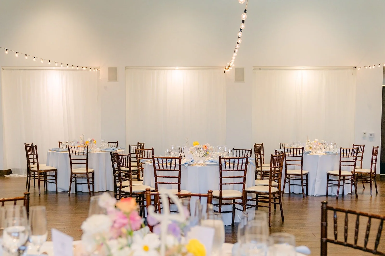 The parlor at La Ventura Event Center set with round tables before guests arrived