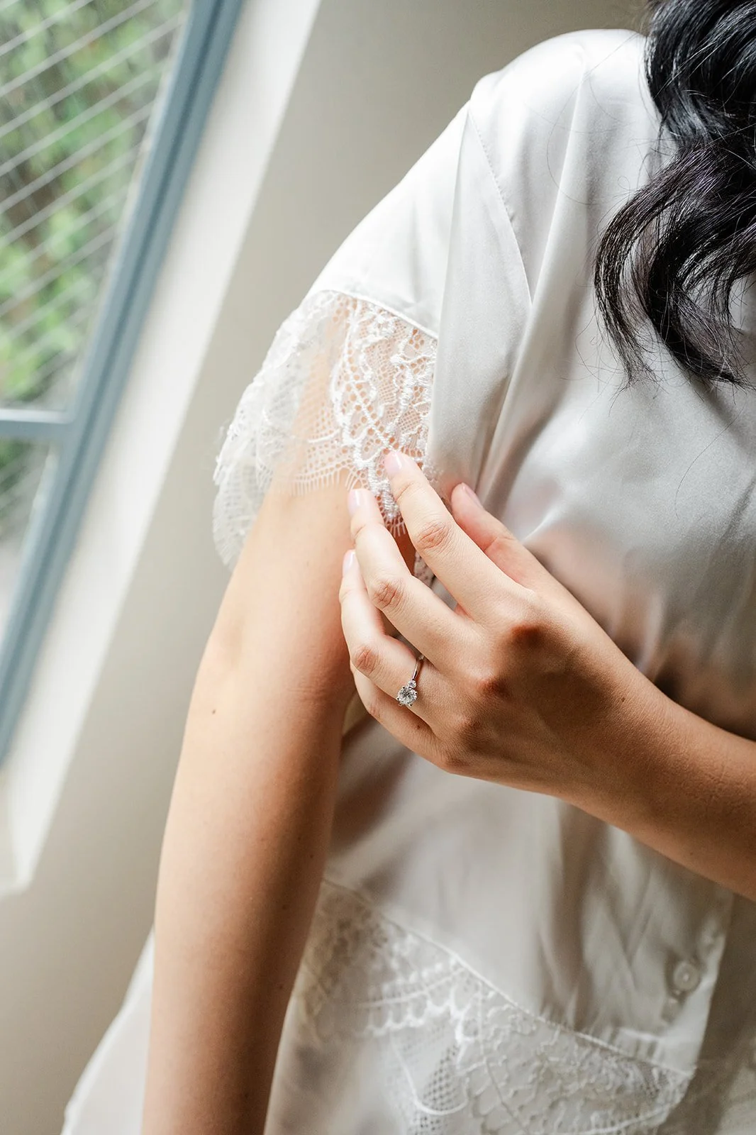 Close up of Constance's engagement ring against her silk robe