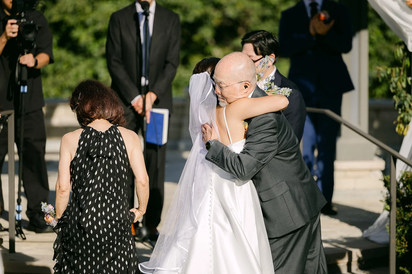 Saya sharing a hug at the top of the aisle