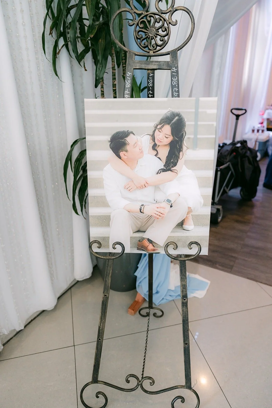 Engagement portrait of Emily and James on an easel at the entrance