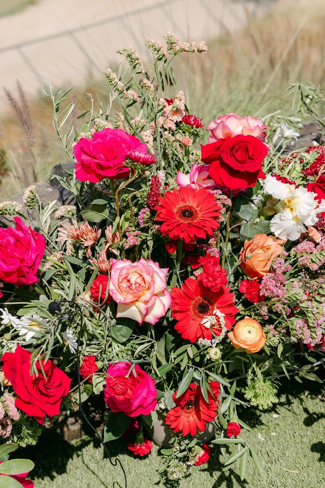 Red and pink ceremony florals by Blooms Design House