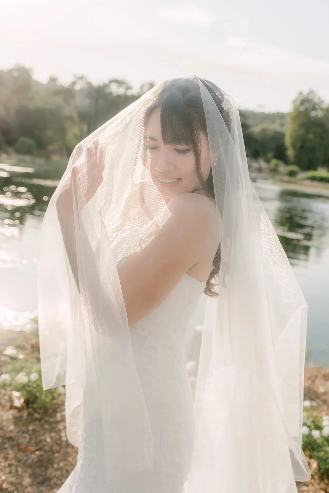Marina smiling under her veil in golden hour light