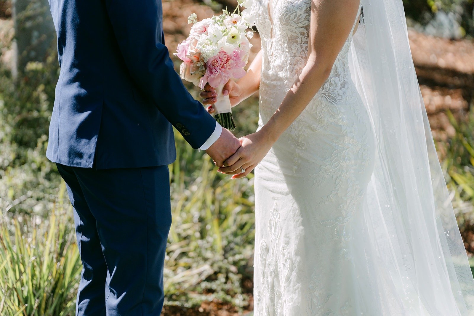 Kelli and Alex holding hands after their first look, photographed by One and Only Production