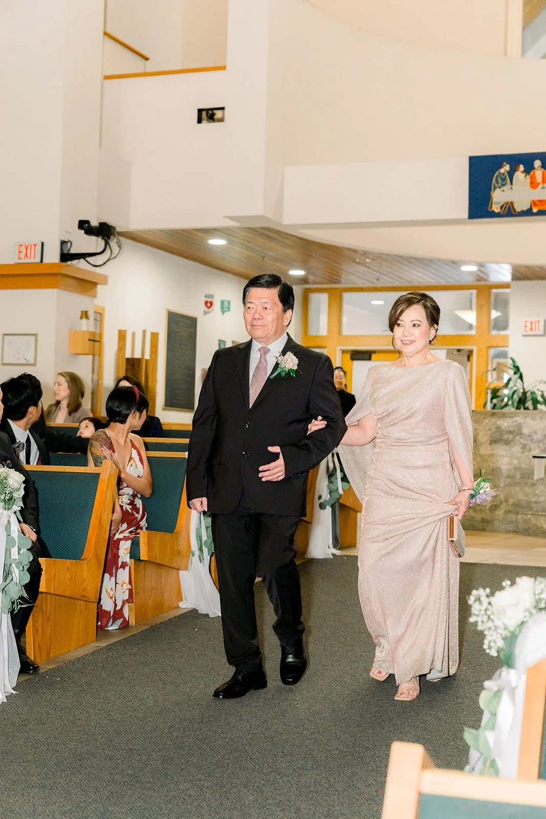 Family walking down the aisle at the start of the ceremony