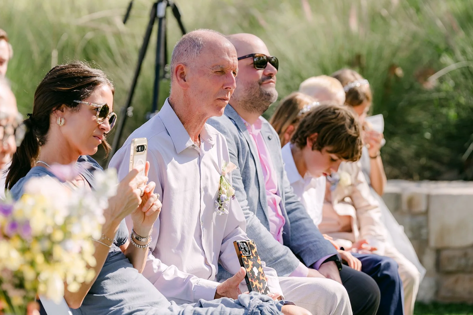 Family members watching the ceremony from the front row.
