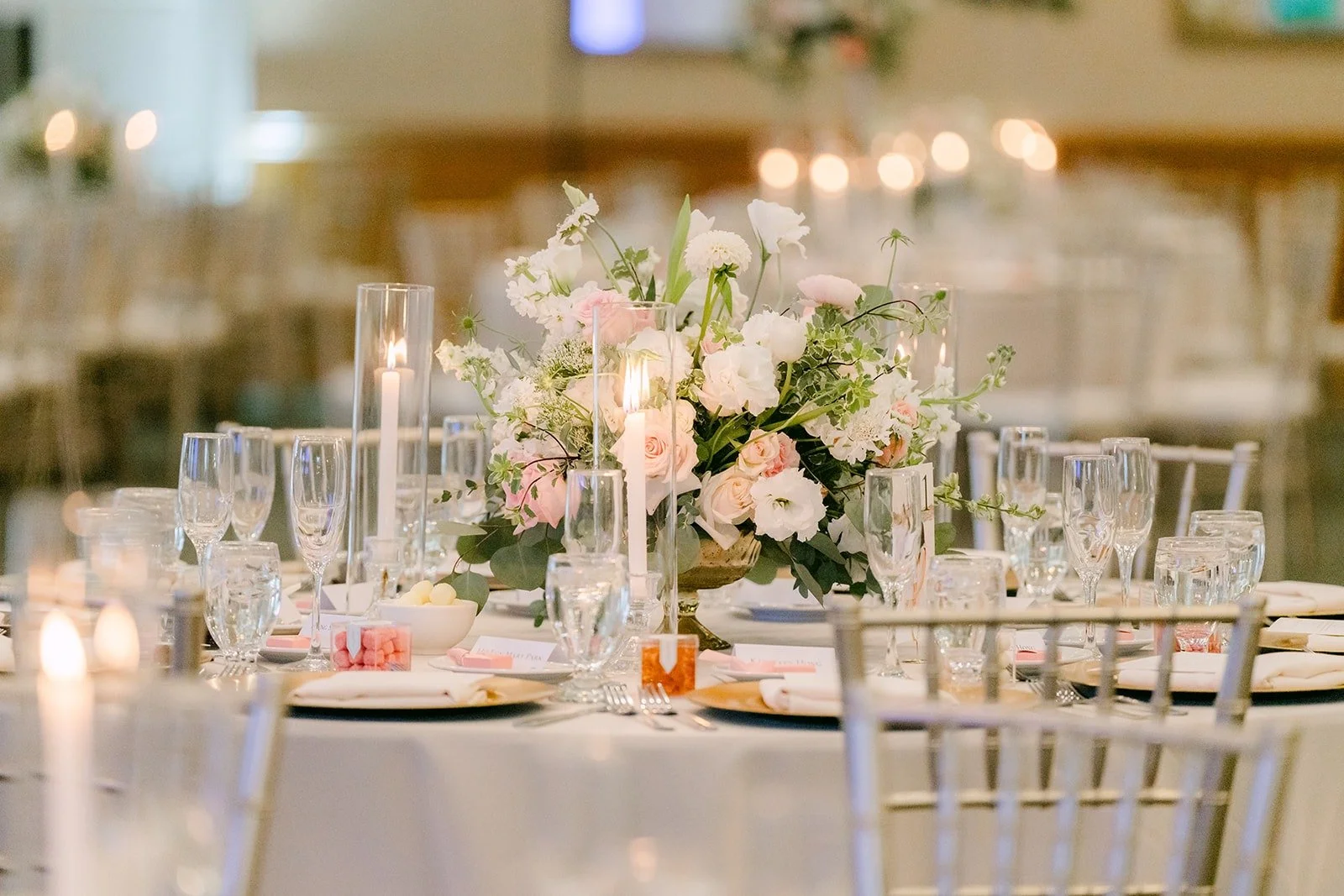 Candles and low florals on a reception table
