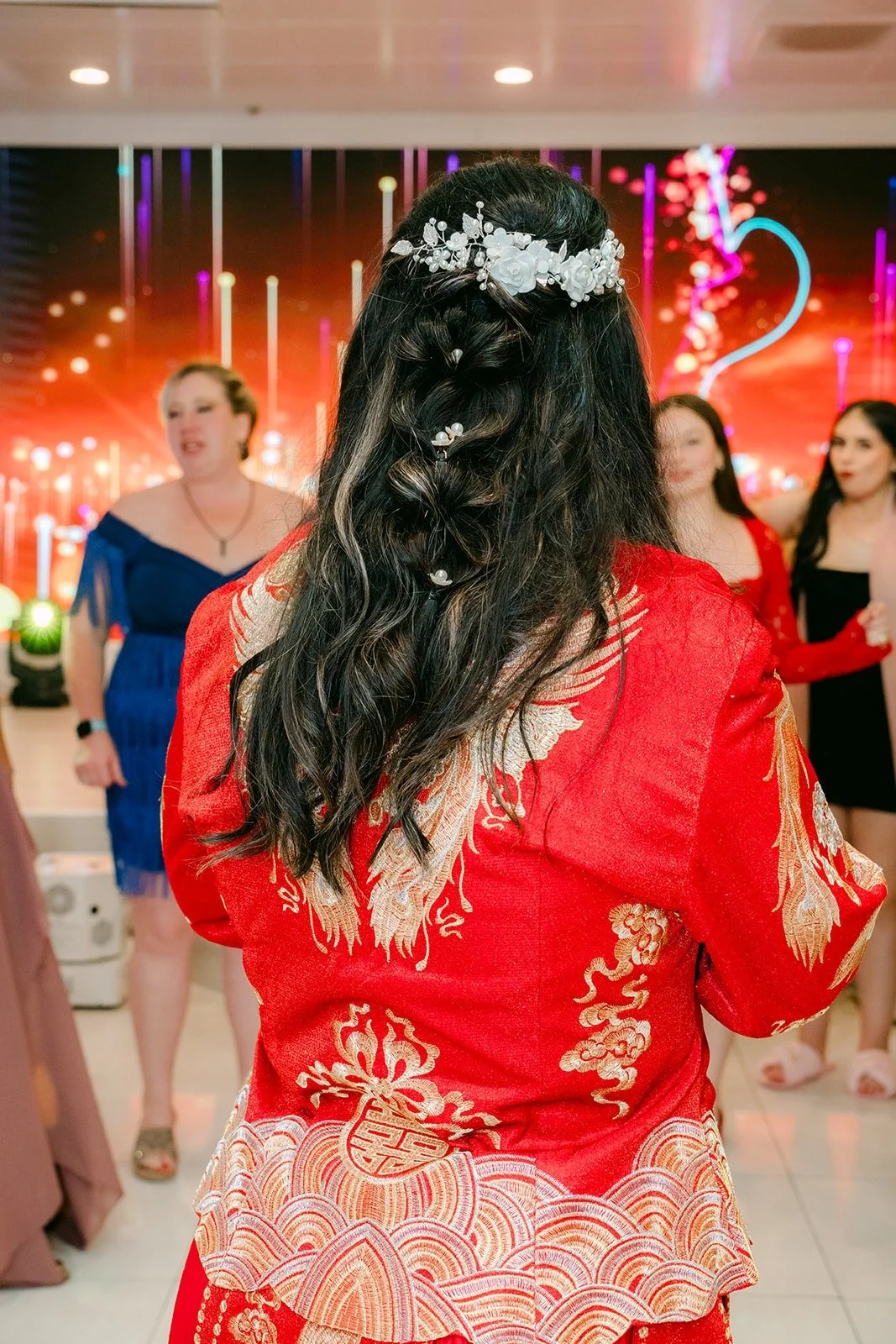 Amy getting ready to toss her bouquet, hair pinned with a jeweled clip