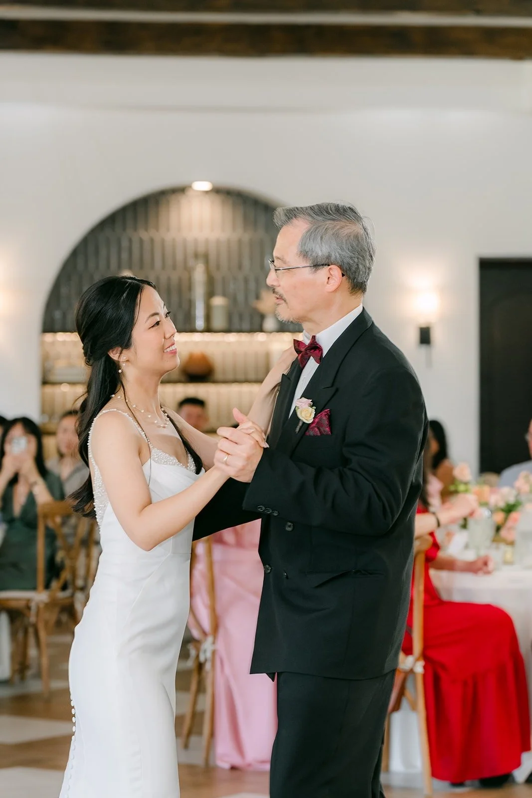 Stephanie dancing with a family member in a black tuxedo