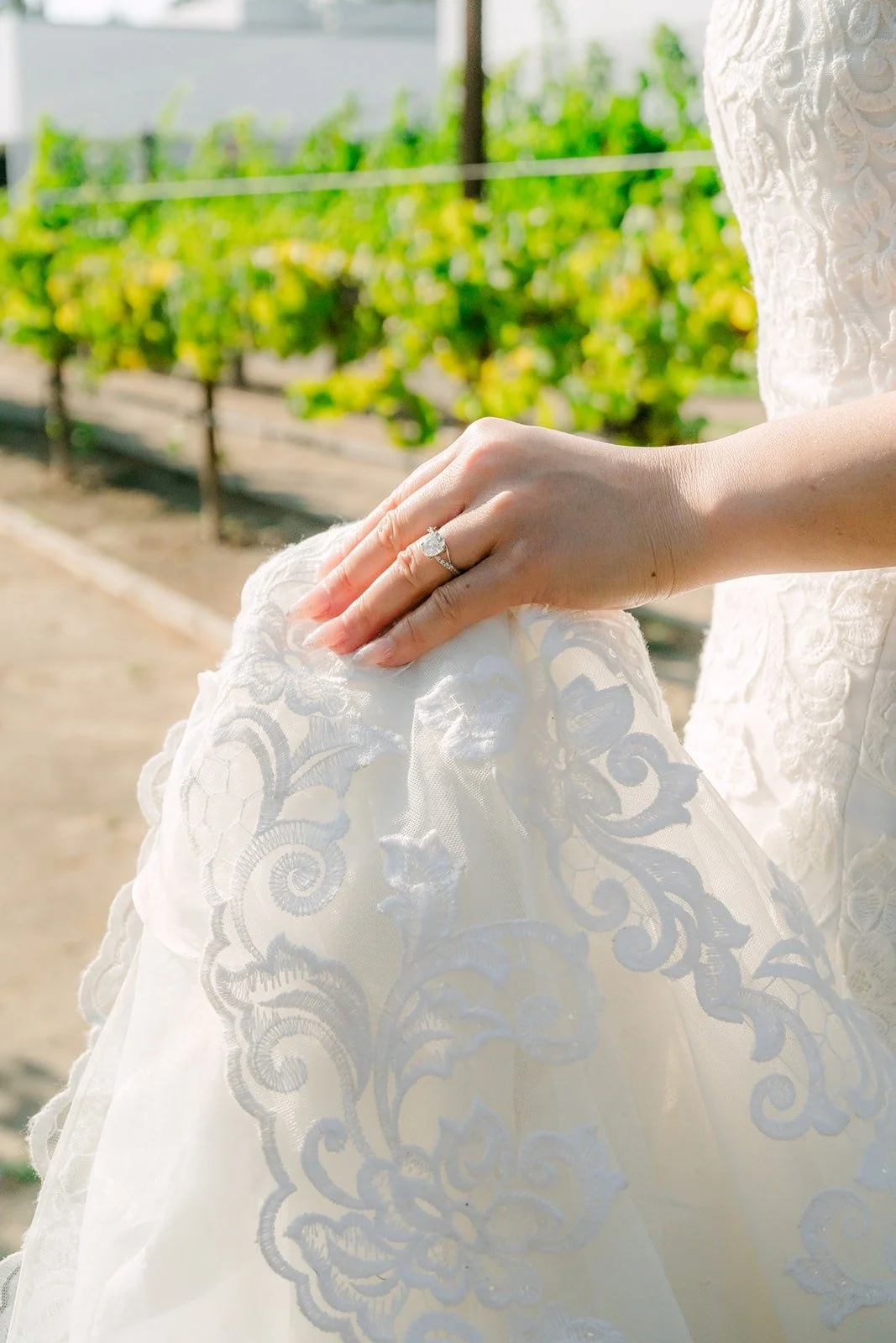 Xuemin holding up the lace of her gown, photographed by One and Only Production