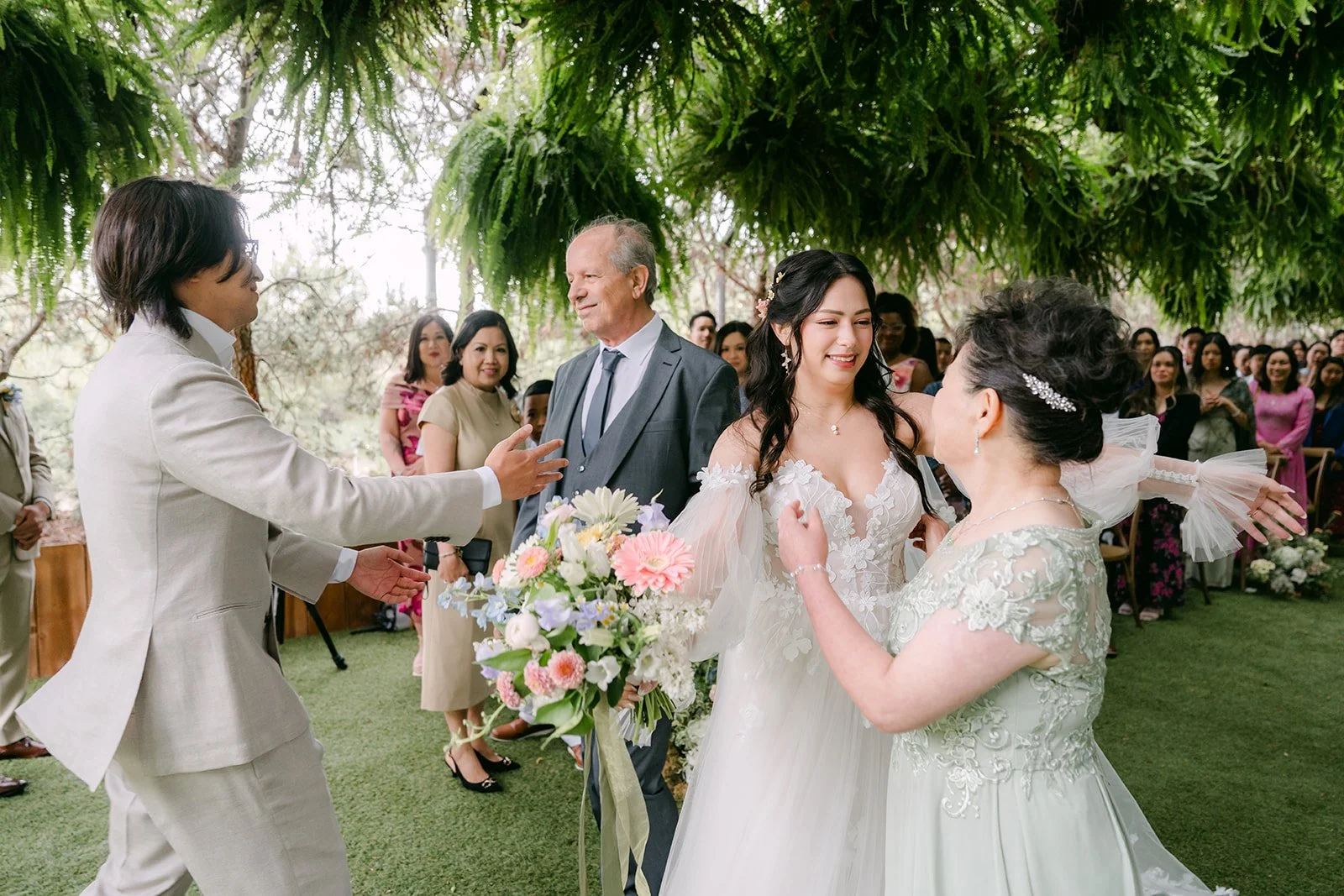 Kat's parents hugging Mike as they give her away