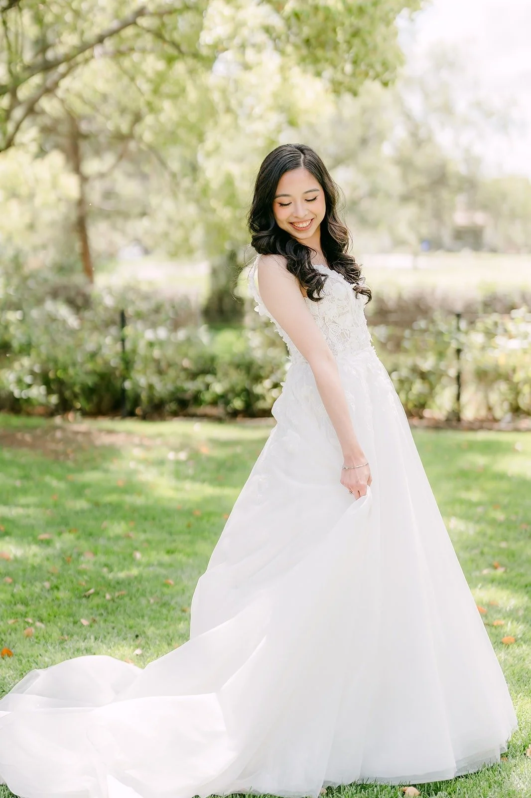 Natalie in her gown with a long train on the lawn at Rio Hondo by Wedgewood Weddings