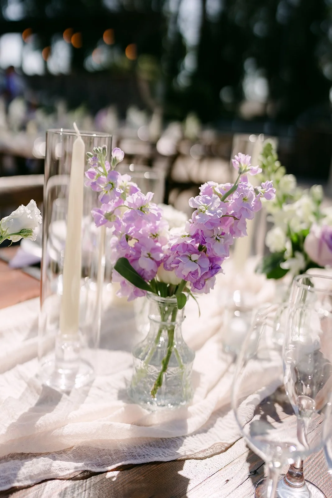 Lavender stock and white blooms in a bud vase centerpiece