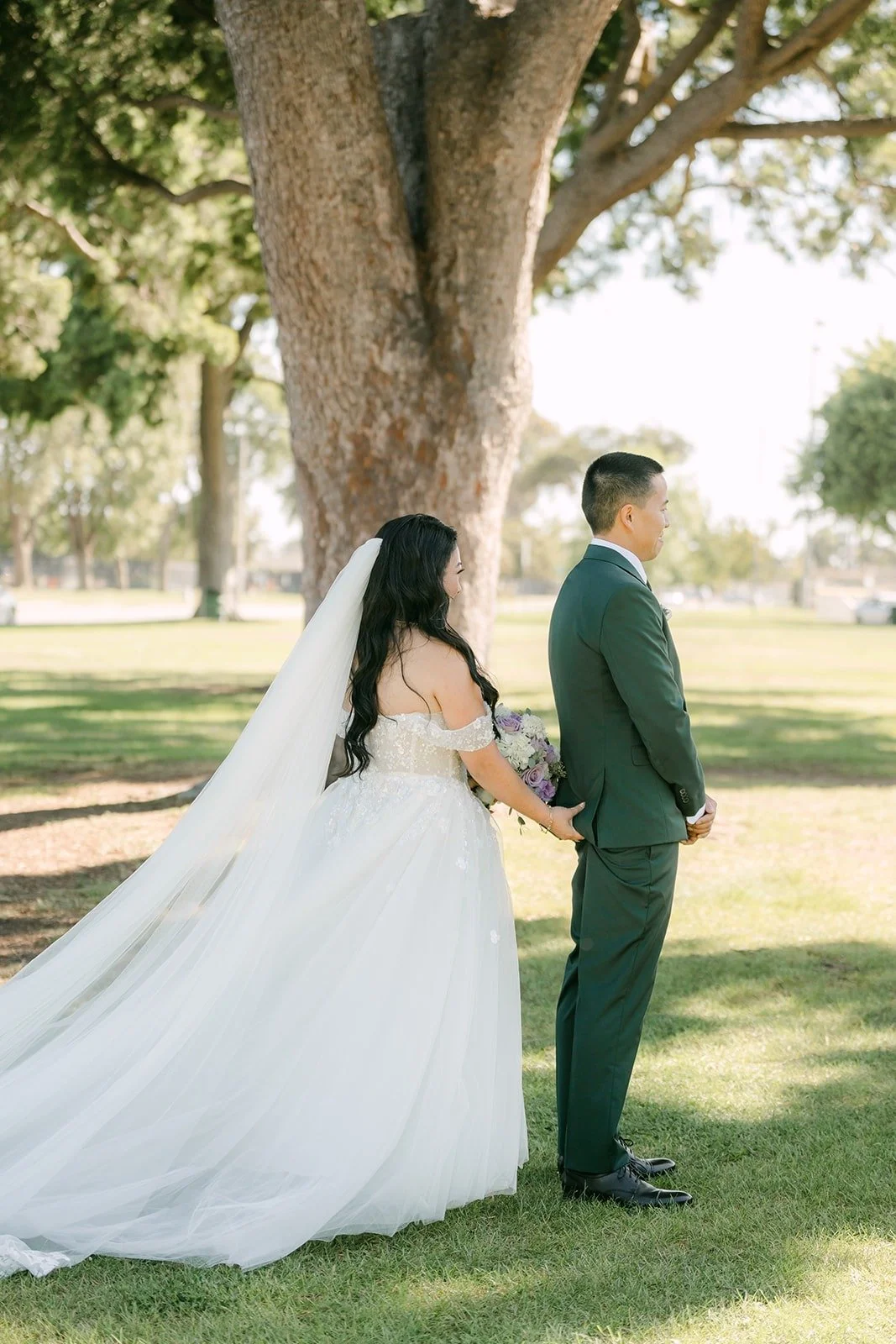 Kevin turns to see Jennifer under the trees at Garden Grove Park