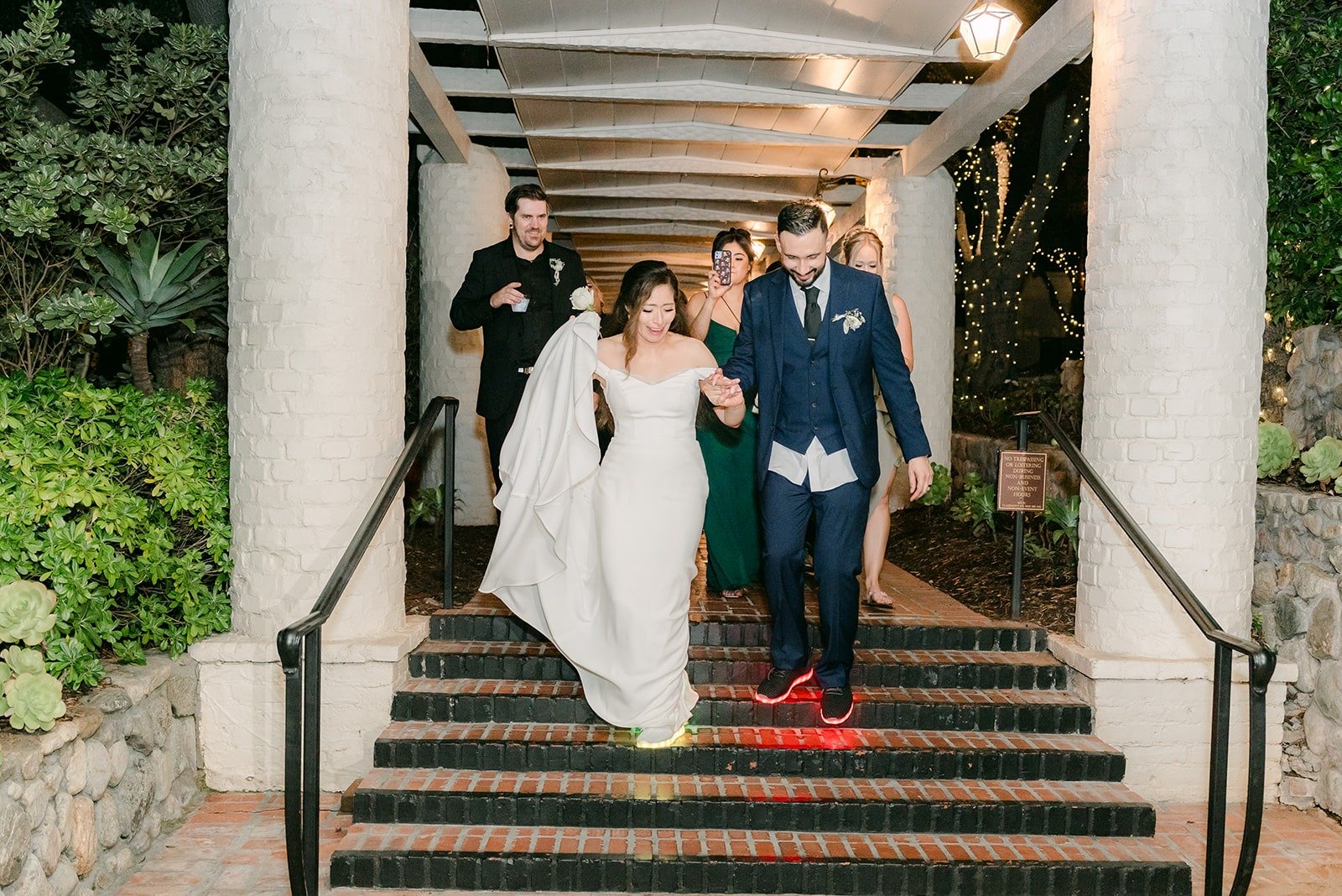 Mariana and Danny walking down the stairs toward their ride