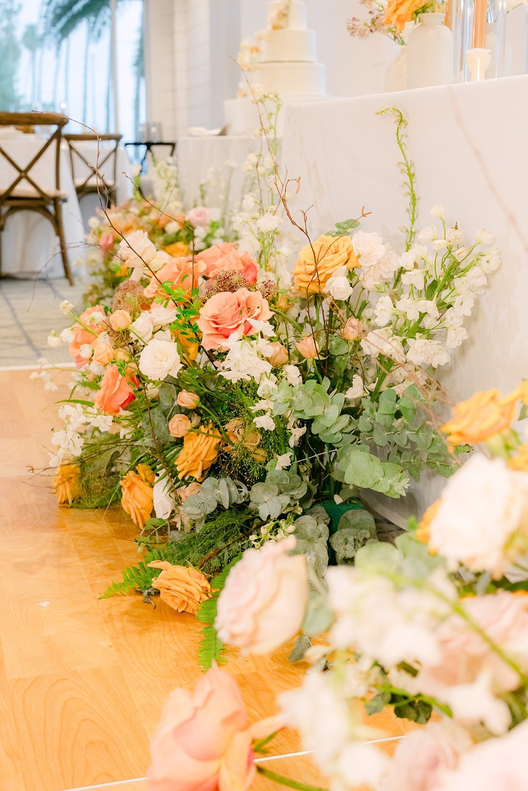 Peach and ivory florals spilling across the sweetheart table