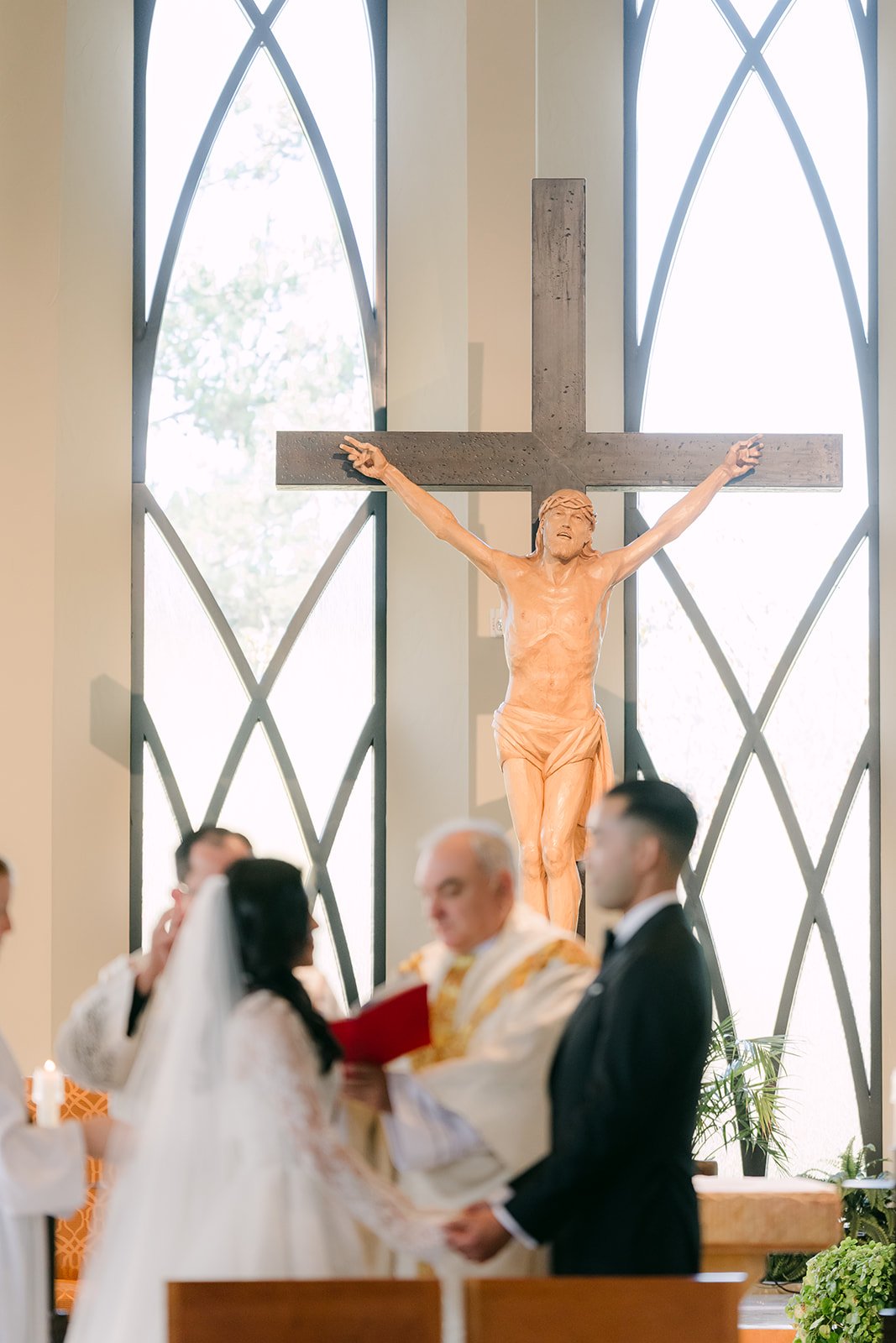 Kim and Vincent kneeling beneath the crucifix