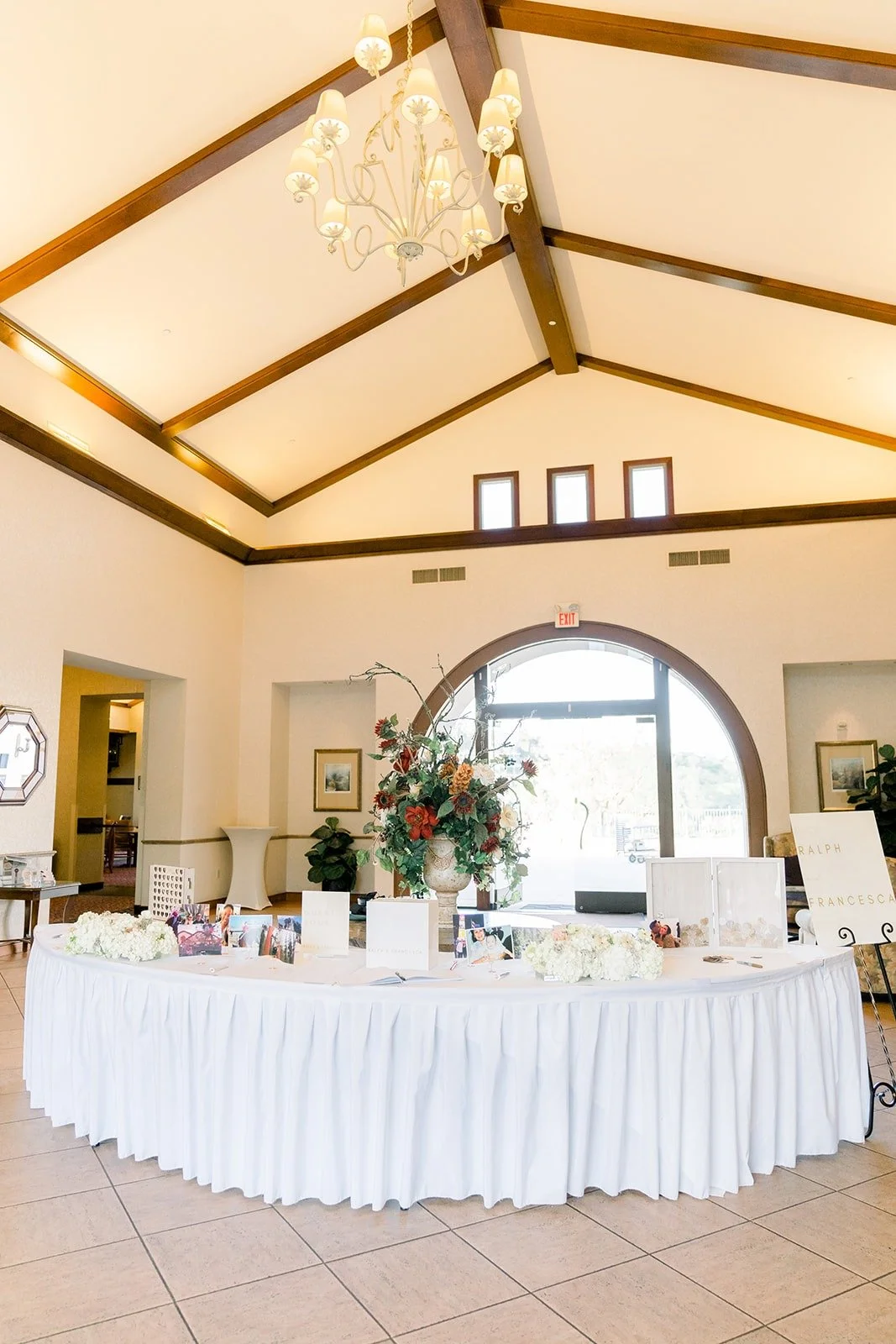 The cake table under the wood beamed ceiling in the reception room