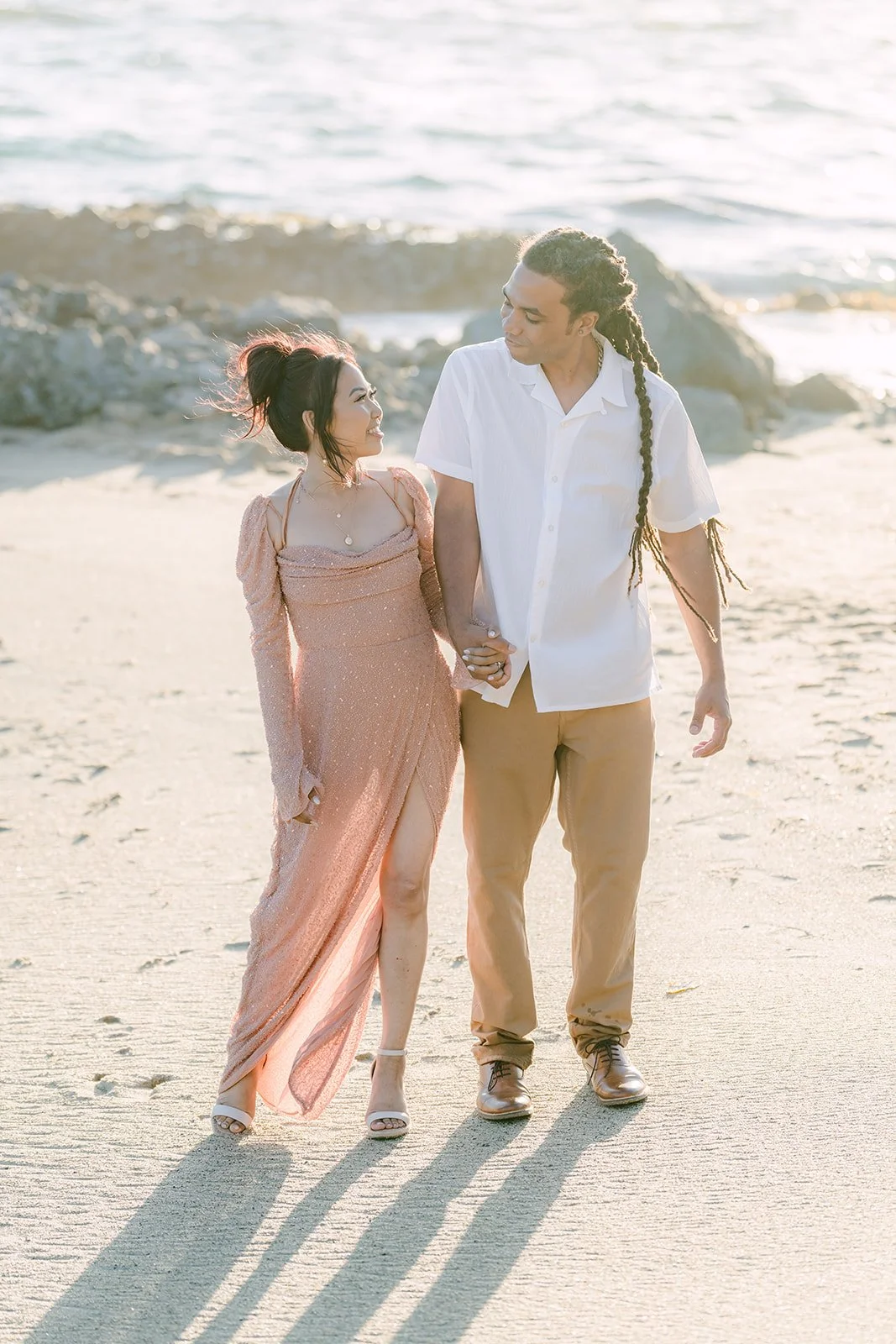 Amy and Michael walking together in the afternoon sun, photographed by One and Only Production.