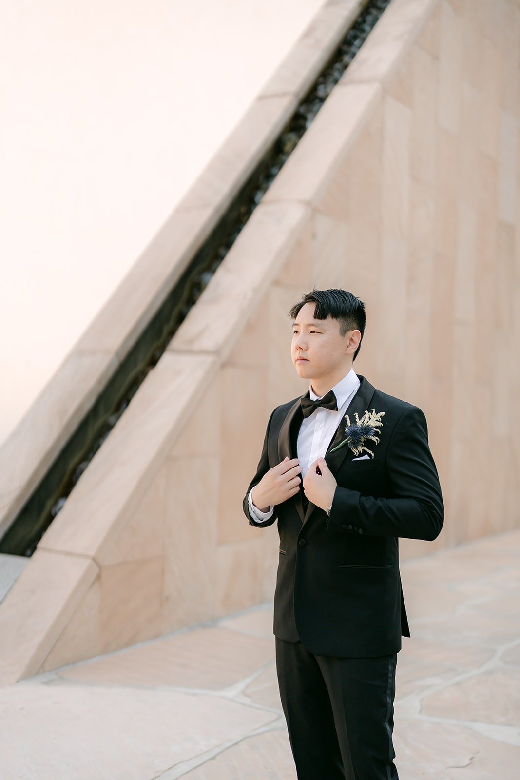 James buttoning his jacket in the Noguchi Garden