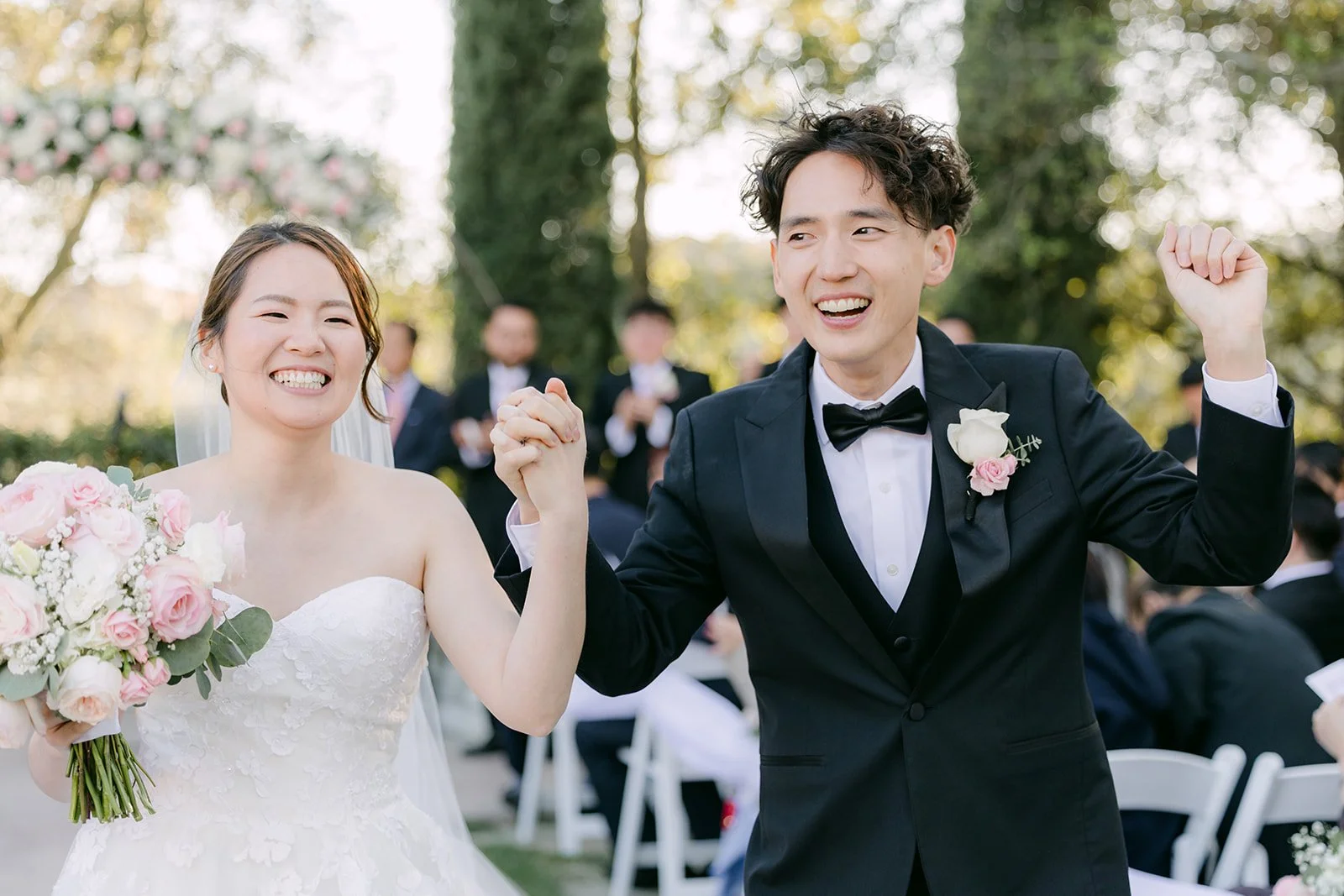 Victoria and Tony cheering as they walk back up the aisle
