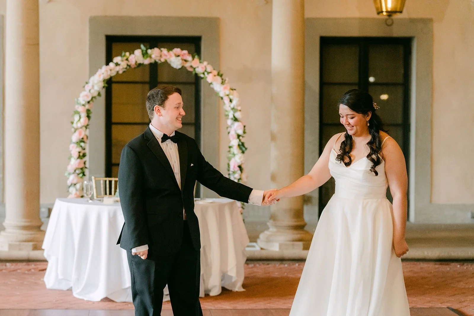 Matthew spinning Saira in front of the rose arch
