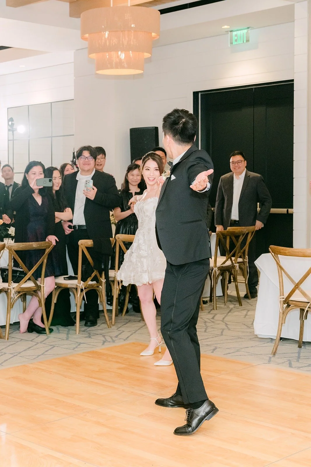 Angela twirling under Eli's arm during their first dance
