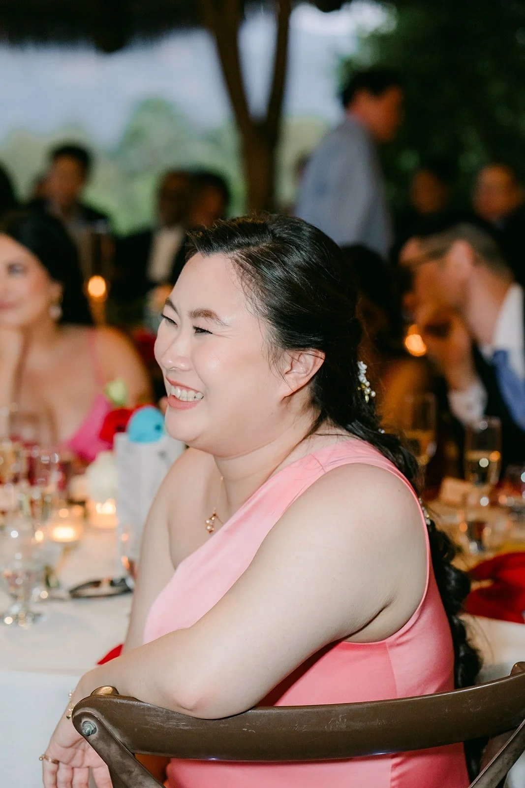 A bridesmaid laughing during the speeches
