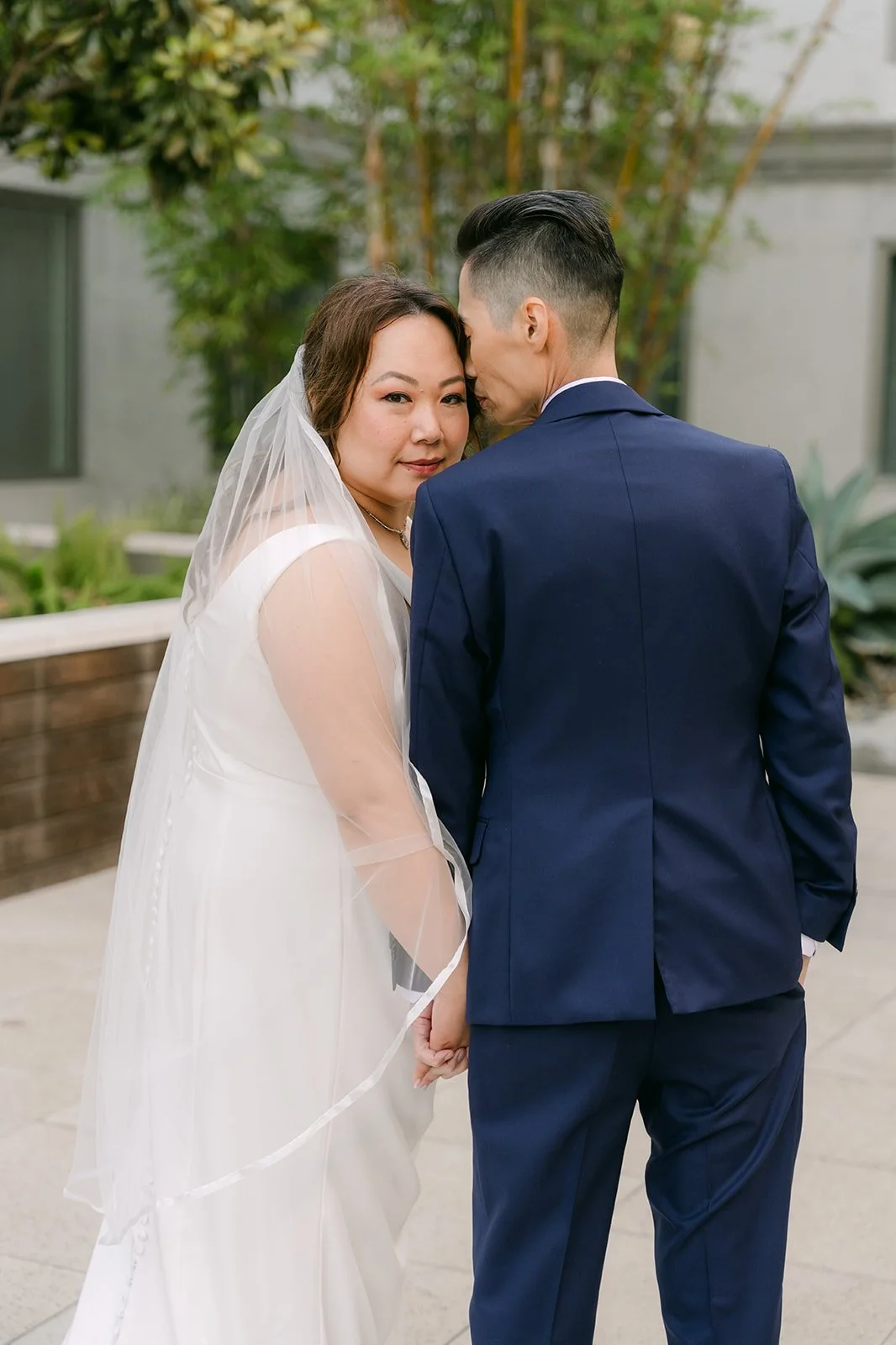 Mai and Bobby leaning in close.