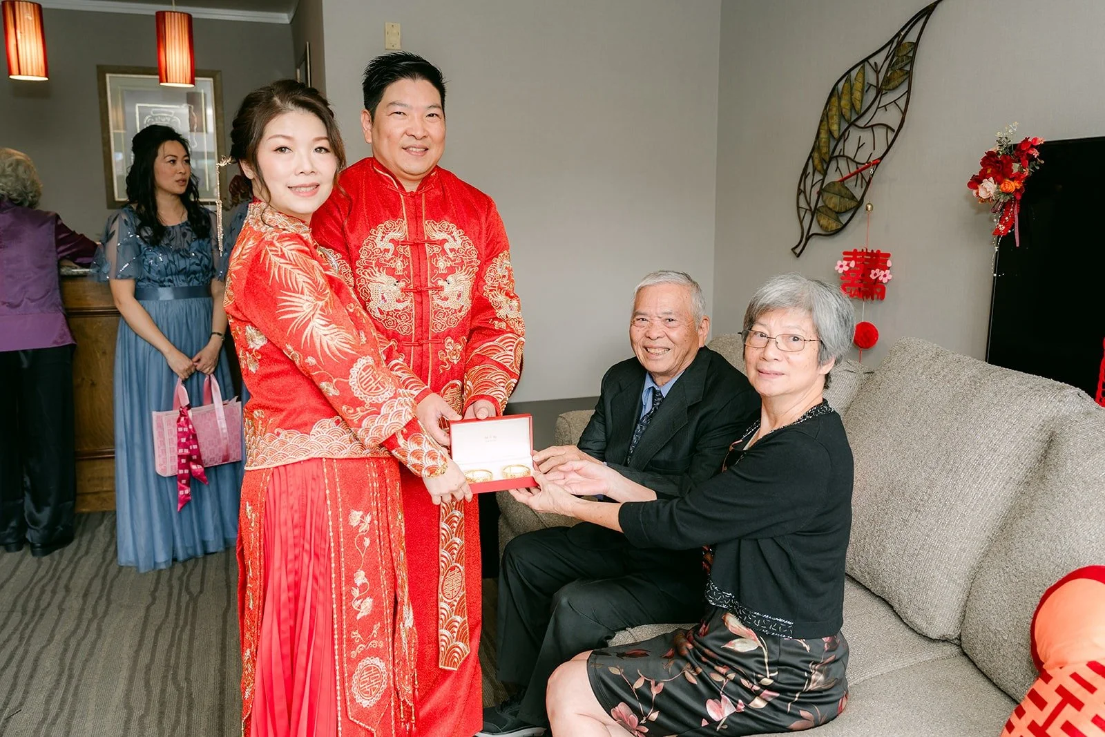 Sochi and Jay pose with two family members after serving tea