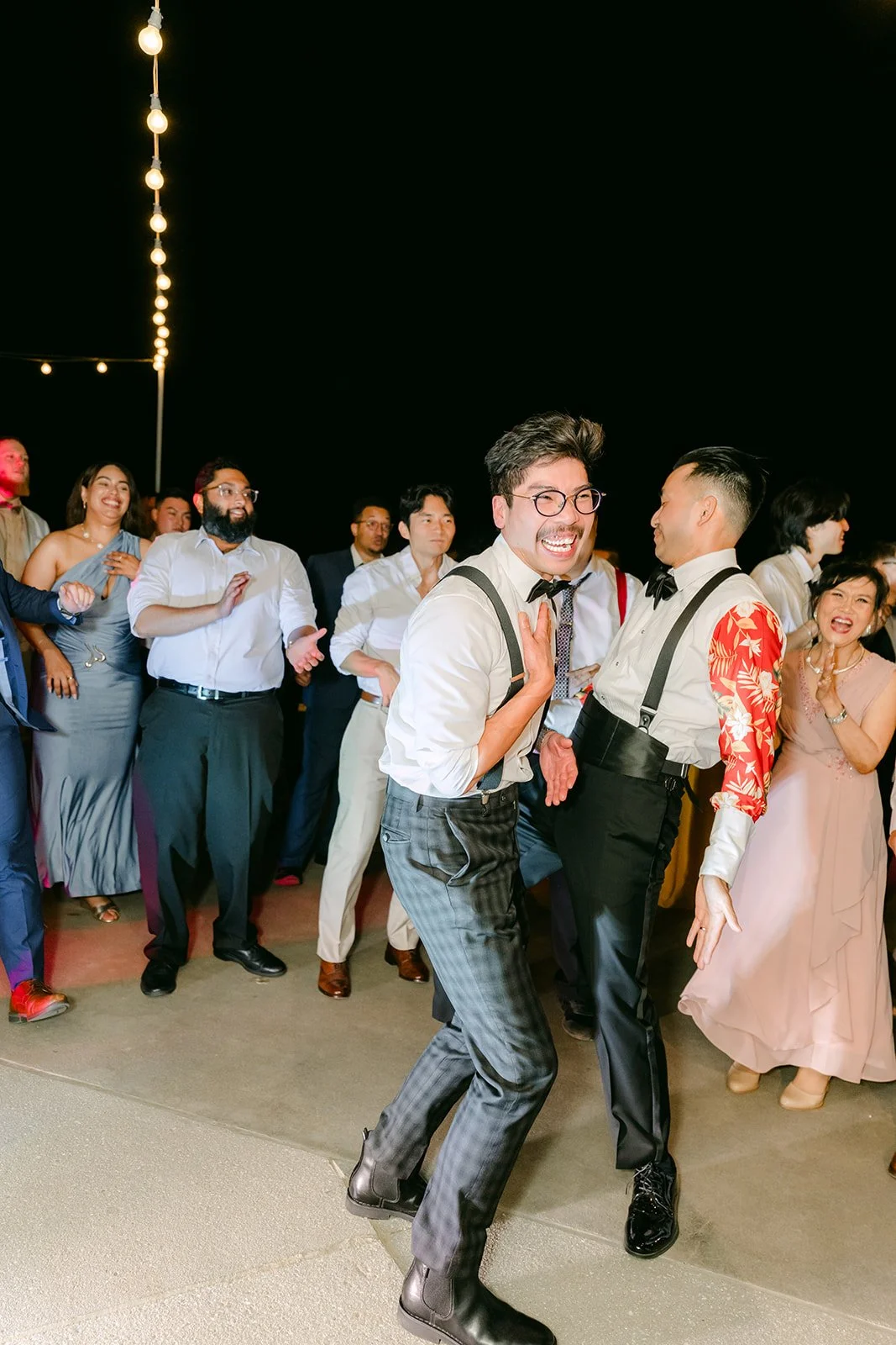 Groomsmen dancing in the middle of the floor
