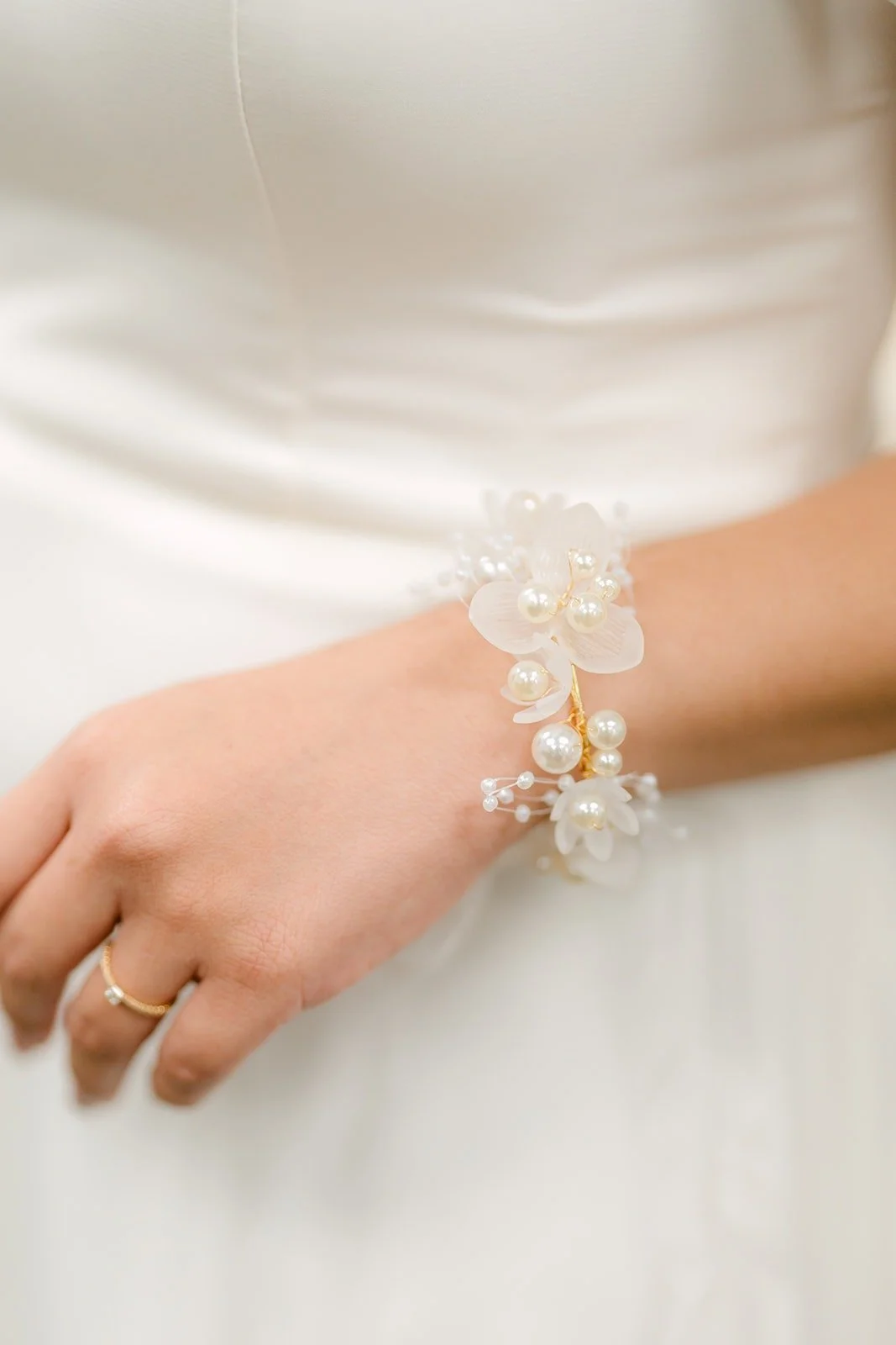 Close up of Ivy's crystal bracelet and engagement ring
