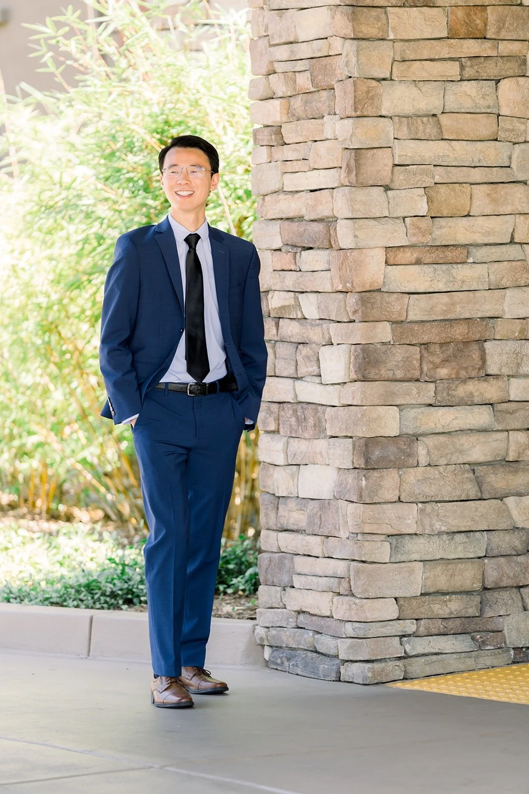 Full length portrait of Alex outside the groom's room