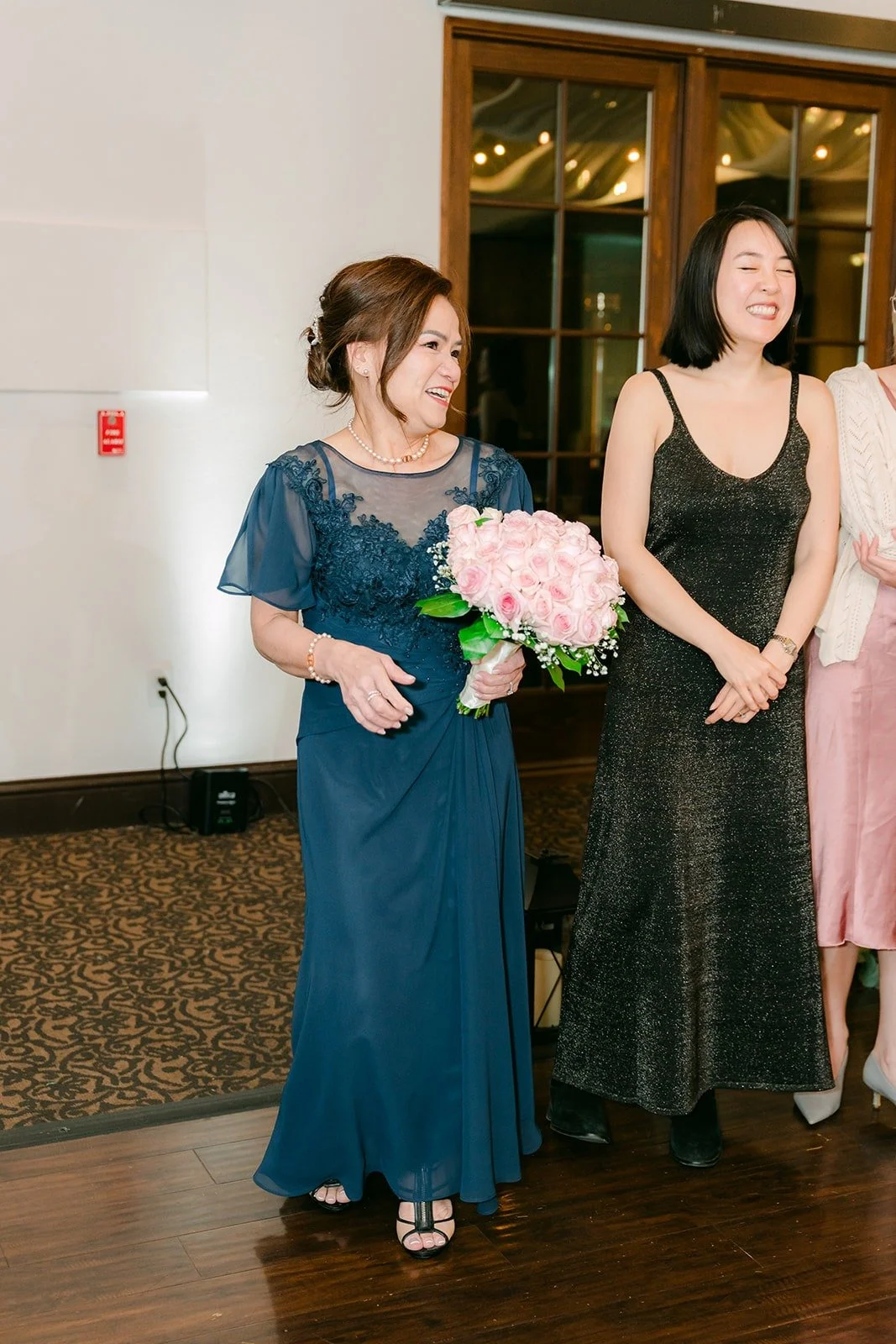 Ivy's mom holding the bouquet after the handoff